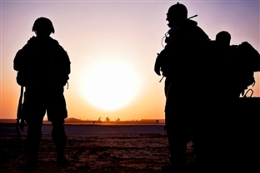 U.S. Army soldiers wait in the early morning for two UH-60 Black Hawk helicopters to pick them and bring them to a nearby town to conduct a patrol in Taji, Iraq, Sept. 18, 2009. The soldiers are assigned to the 1st Cavalry Division's Company F, 3rd Battalion, 227th Aviation Regiment, 1st Air Cavalry Brigade.