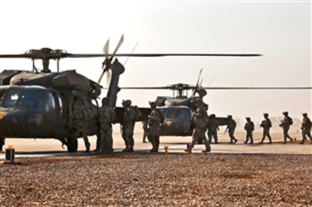 U.S. Army soldiers load into two Black Hawk helicopters as they prepare to fly to a nearby town and conduct a presence patrol in Taji, Iraq, Sept. 18, 2009. The soldiers are assigned to the 1st Cavalry Division's Company F, 3rd Battalion, 227th Aviation Regiment, 1st Air Cavalry Brigade.