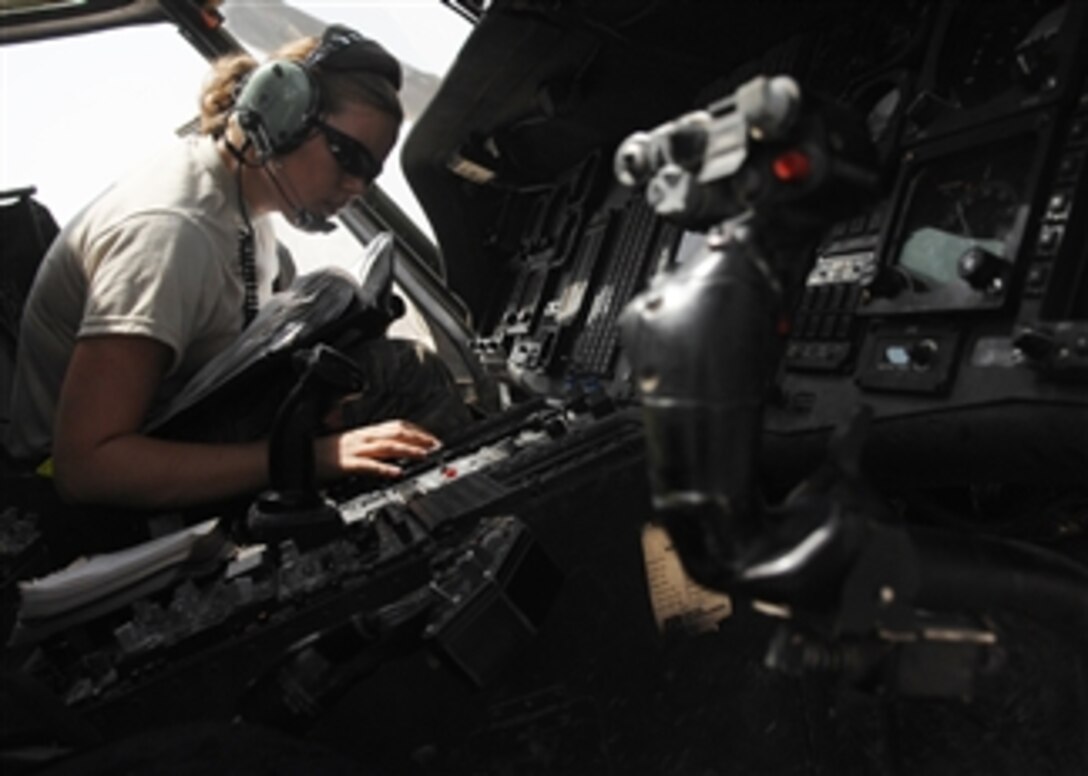 U.S. Air Force Senior Airman Casey Hardy, of the 64th Expeditionary Helicopter Maintenance Squadron, conducts an inertial navigation system in-flight write-up aboard an HH-60G Pave Hawk helicopter at Joint Base Balad, Iraq, on Sept. 1, 2009.  The write-up helps ensure the Pave Hawk is mission capable and fully operational.  