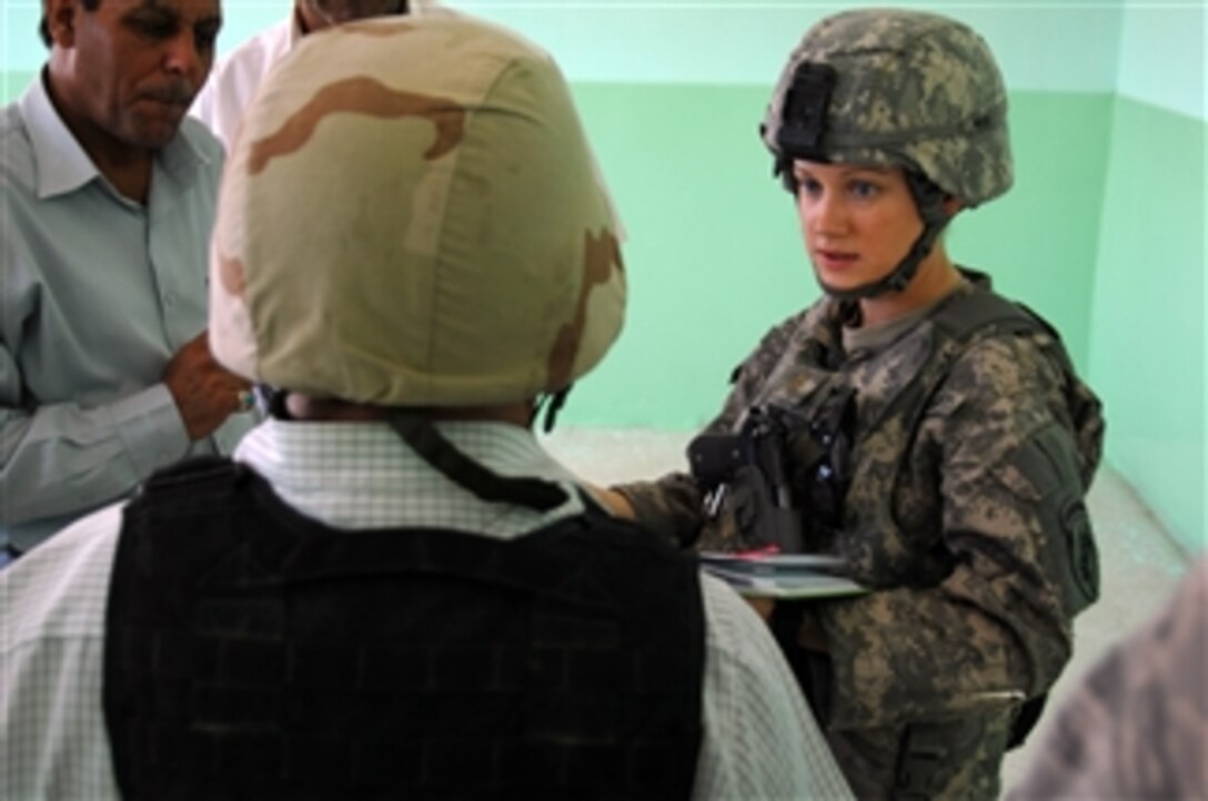 U.S. Army 2nd Lt. Jennifer Neve from the 308th Civil Affairs Battalion meets with the Director General of Education at Numaniyah, Iraq, on Sept. 15, 2009.  The team visited to inspect the construction of the new Information Technology Education Center.  DoD photo by Staff Sgt. Brien Vorhees, U.S. Army.  (Released)