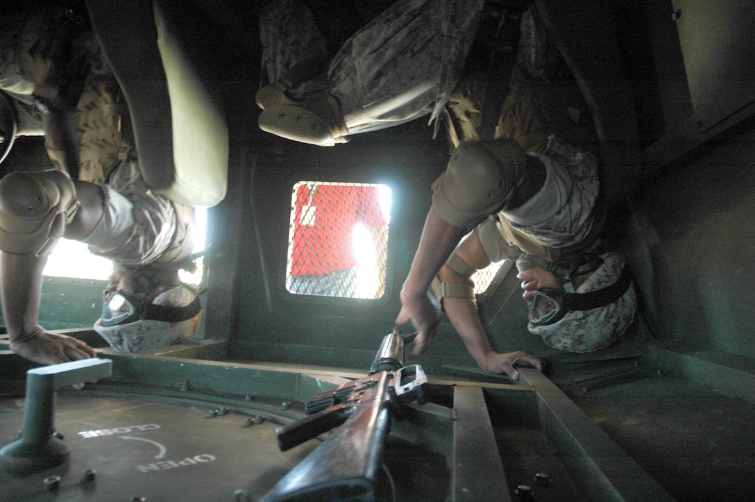 A Humvee Egress Assistance Trainer flips Gunnery Sgt. Maxwell Williams, left, and Staff Sgt. Lamar Irby as it rolls over at the Marine Corps Air Station in Yuma, Ariz., Sept. 22, 2009. “It was pretty intense,” said Irby. “The intent behind it is to give the mindset of what a rollover is like and to educate on how to minimize injuries if you’re ever in a rollover,” said Irby. The station received their trainer May 8, and approximately 200 Yuma-based Marines have received the training. The HEAT was adopted by the Corps Feb. 27, 2003, to decrease the deaths attributed to Humvee rollovers. According to the station safety department, 246 deaths and 900 injuries from rollovers were reported from January 2003 to August 2008. The HEAT is also a predeployment training requirement.