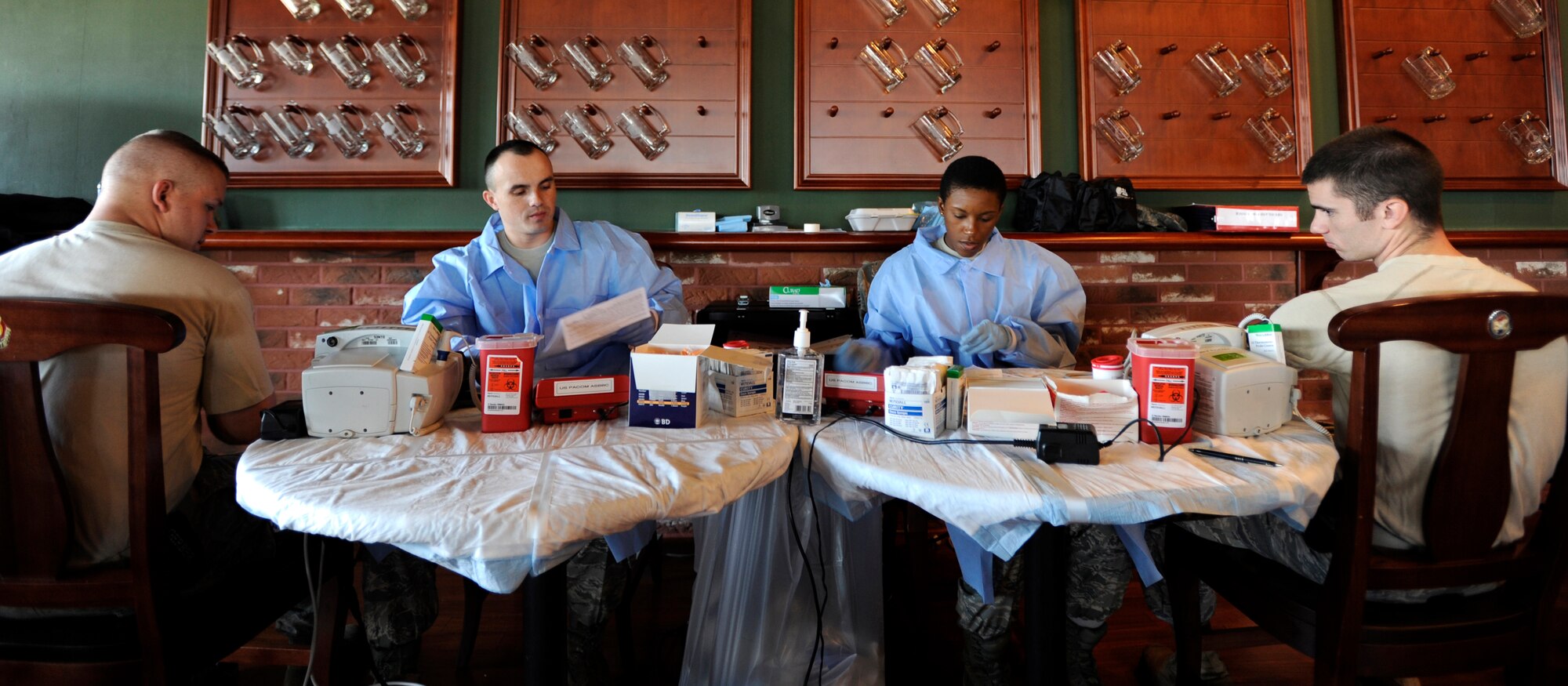 Staff Sgt. Edgar Ferriera, left, and Zaynah Hammad check vital signs before Airmen donate during the base wide blood drive at Osan Air Base, Republic of Korea, Sept. 23. Sergeants Ferriera and Zaynah are part of the ten member team from U.S. Pacific Command Armed Services Blood Bank Center in Okinawa, Japan, The PACOM Armed Services Blood Bank distributes blood products to Okinawa, 12 hospitals throughout PACOM, sevices afloat and deployed units of Operations Iraqi and Enduring Freedom.  (U.S. Air Force photo/Senior Airman Stephenie  Wade)