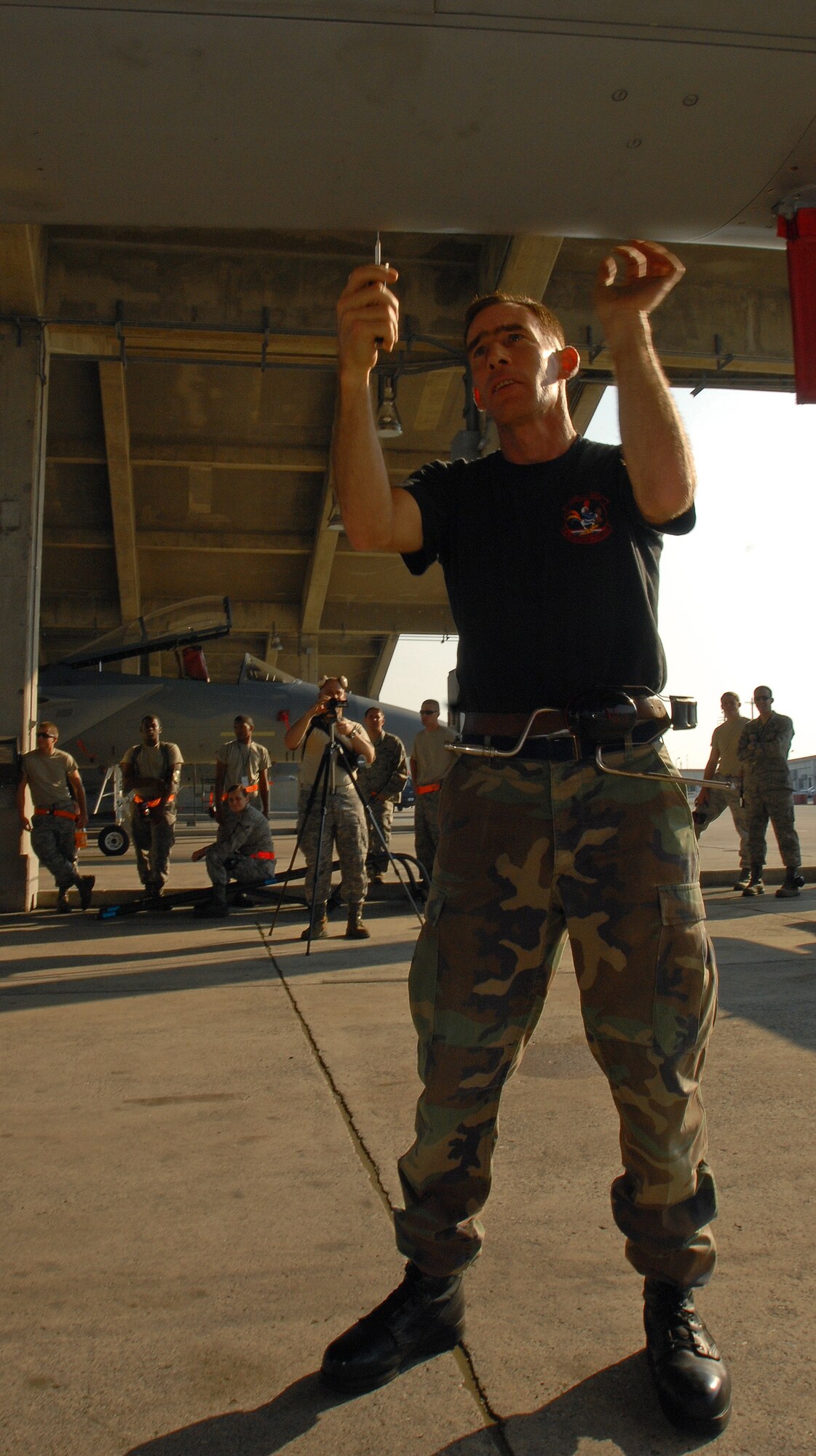 KADENA AIR BASE, Japan -- Senior Master Sgt. Robert Meyer, 67th Aircraft Maintenance Unit's assistant superintendent, prepares an F-15 Eagle for AIM-120 Advanced Medium-Range Air-to-Air missiles. The 28-year veteran weapons loader prepped his last aircraft hours before holding his retirement ceremony with friends and family on Kadena's spot 50. Sergeant Meyer spent more than 17 years of his career at Kadena. (Air Force/Staff Sgt. Jason Lake)