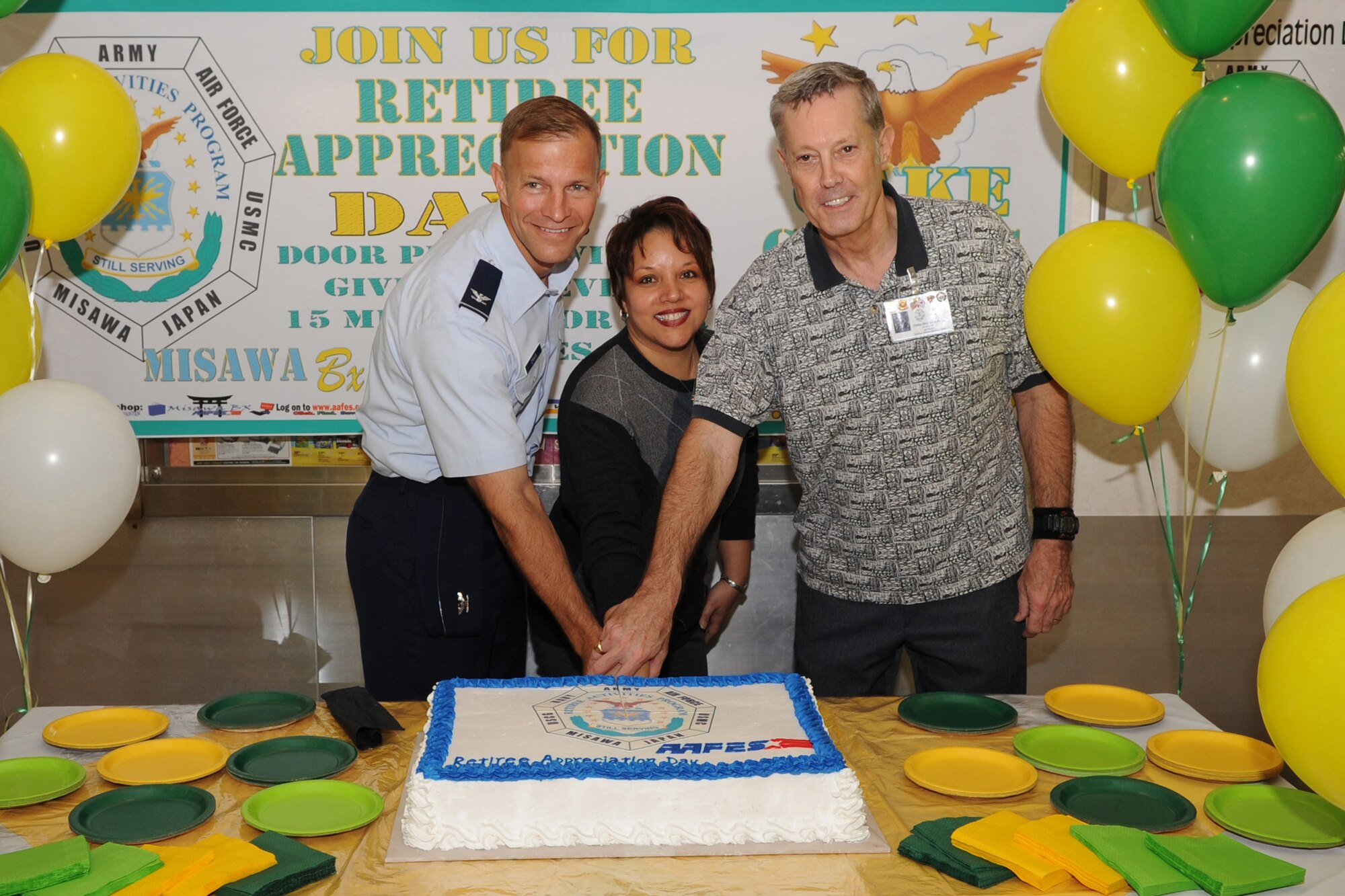 MISAWA AIR BASE, Japan -- Col. R.C. Craig, 35th Fighter Wing vice commander, Rita Inchaurregui-Powell, AAFES sales and merchandise manager, and Mr. David Barton, Misawa Air Base Retirees Activities Office director, cut the ceremonious cake Sept. 19 at the Misawa Base Exchange. The cake-cutting ceremony marked the official start of the 9th annual Misawa Military Retiree Appreciation Day. The RAO at Misawa supports a retiree population of approximately 450 retirees, dependants and survivors from all branches of the service in Northern Japan. (U.S. Air Force photo/Senior Airman Jamal D. Sutter)