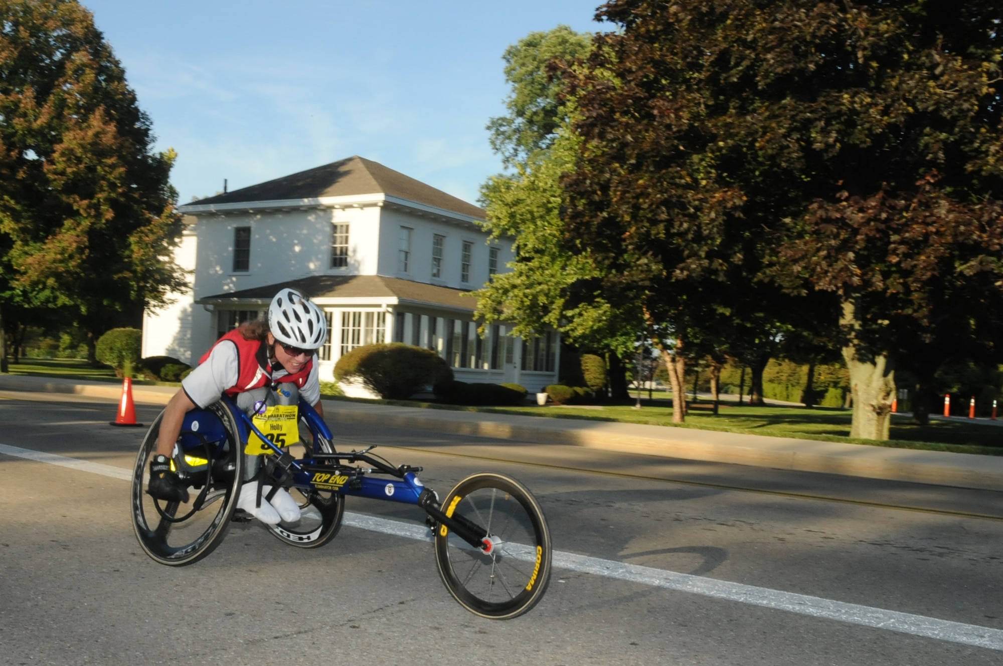 Wheel racer Holly Koester passes Arnold House, oldest building at Wright-Patterson Air Force Base, during the 13th U.S. Air Force Marathon Sept. 19, 2009.  Nearly 10,000 runners participated. Koester, from Cleveland, Ohio, has wheeled in all but one of the annual events, timed to coincide with the anniversary of the creation of the Air Force as a separate service. (Air Force photo/Al Bright)