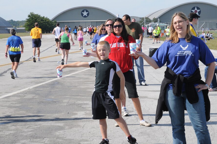 Volunteers hand out cups of water to runners in the 2009 Air Force Marathon. Marathon officials estimate more than 2,000 volunteers will be needed to support the three-day event this year. (U.S. Air Force photo/Al Bright)
