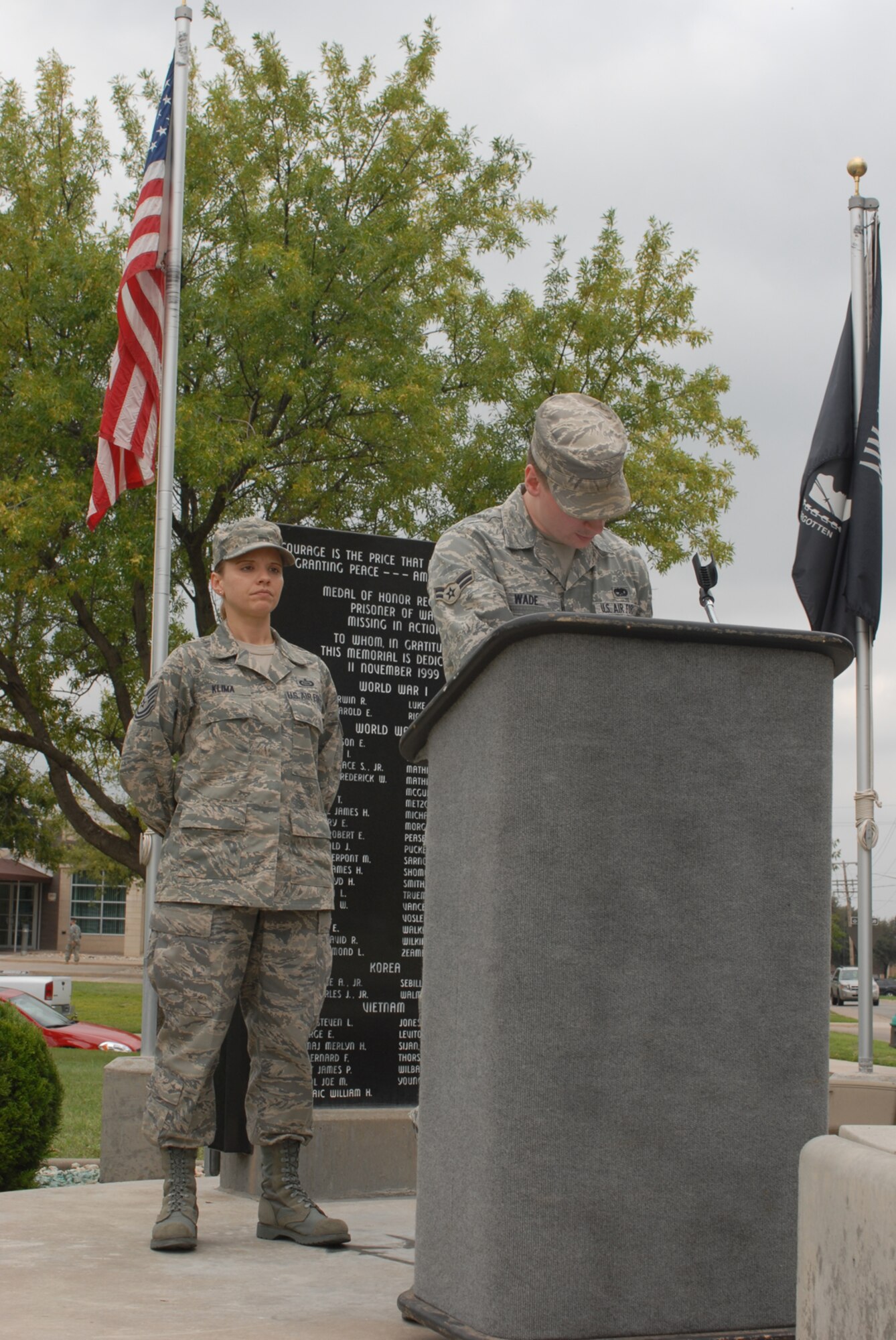 GOODFELLOW AIR FORCE BASE, Texas -- Airman 1st Class Patrick Wade, 17th Communications Squadron, reads the names of prisoners of war and servicemembers who are missing in action while Tech. Sgt. Jennifer Klima, 315th Training Squadron, stands vigil at the POW/MIA memorial, Sept. 18, 2009. Base personnel stood a 24-hour vigil honoring POWs and MIAs. (U.S. Air Force photo/Airman Clayton Lenhardt)