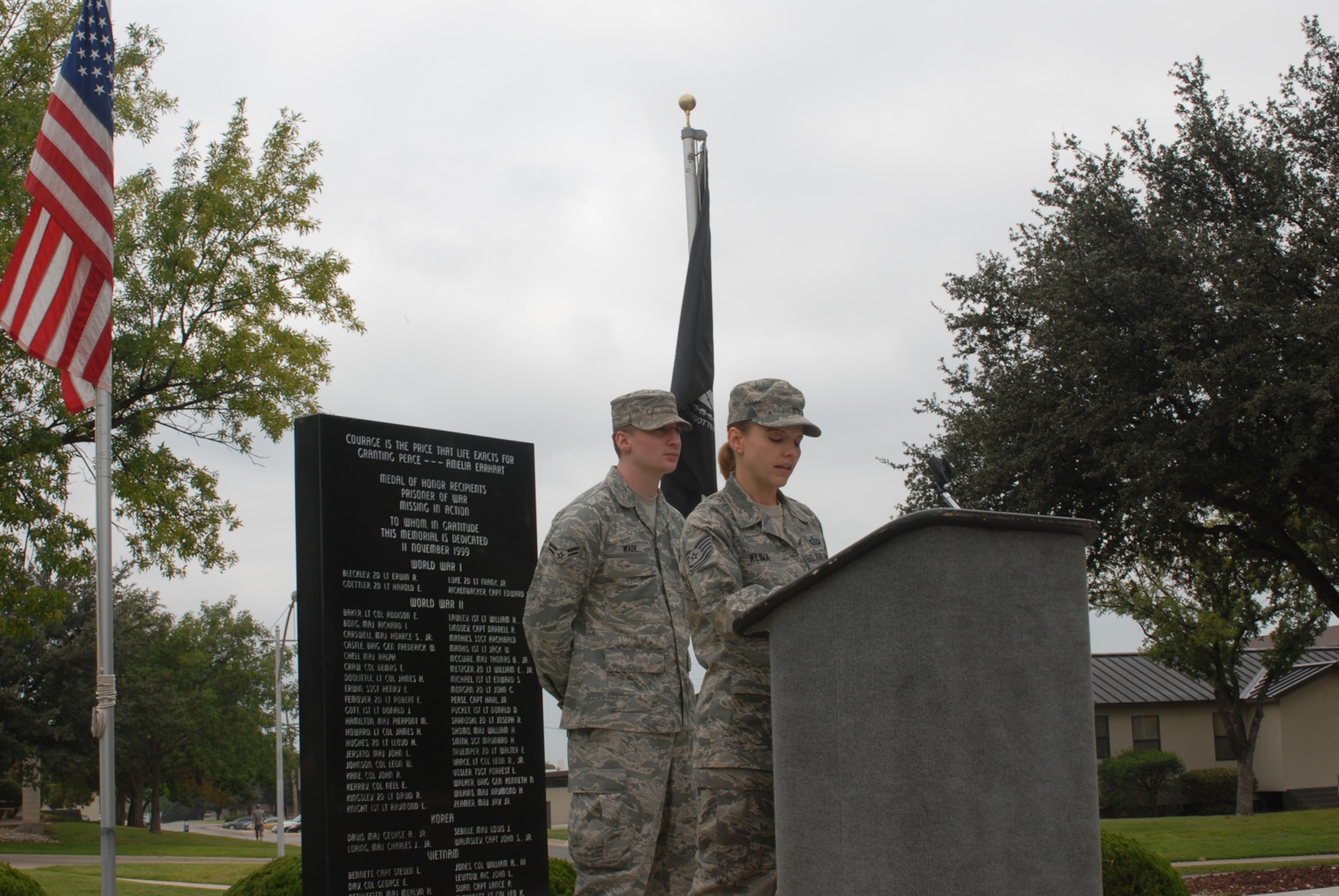 GOODFELLOW AIR FORCE BASE, Texas -- Tech. Sgt. Jennifer Klima, 315th Training Squadron, reads the names of prisoners of war and servicemembers who are missing in action while Airman 1st Class Patrick Wade, 17th Communications Squadron, stands vigil at the POW/MIA memorial, Sept. 18, 2009. Base personnel stood a 24-hour vigil honoring POWs and MIAs. (U.S. Air Force photo/Airman Clayton Lenhardt)