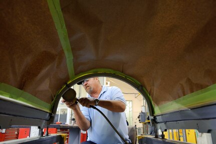 Gary Coats, a structural repair specialist with the 12th Maintenance Directorate, Randolph Air Force Base, Texas, prepares a T-38 canopy for paint after a pressurization seal repair. (U.S. Air Force photo/Steve Thurow)