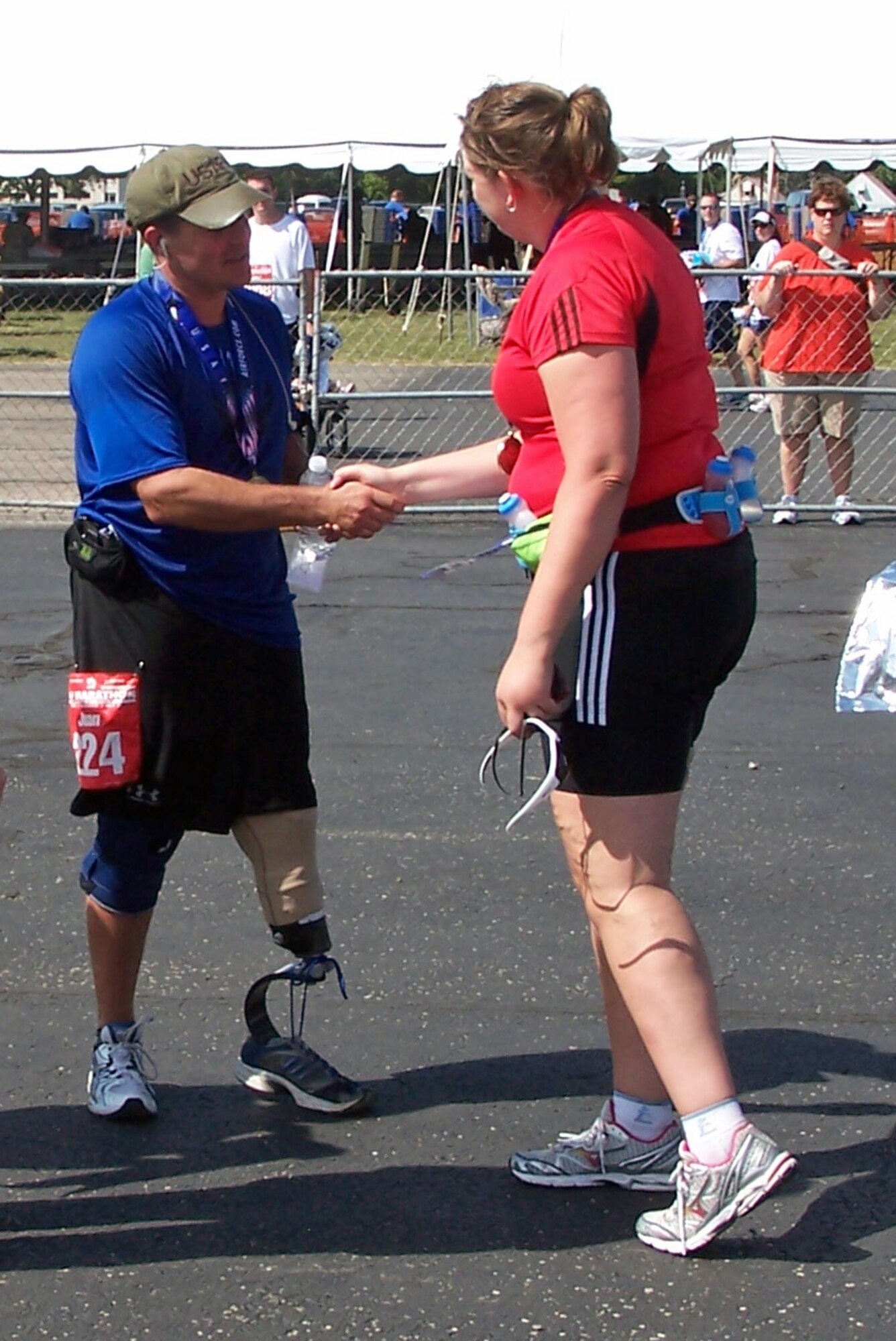 Col. Juan Alvarez is congratulated by a fellow runner after he completed the full marathon Sept. 19, 2009 at Wright-Patterson Air Force Base, Ohio.  The U.S. Air Force Marathon attracted nearly 10,000 runners.  Col. Alvarez lost his left leg in 1996 when the MH-53 he was flying crashed during a special operations counter-narcotics mission over central America.  Col. Alvarez is now the U.S. air attaché to Bolivia. (Air Force photo/Ted Theopolos)