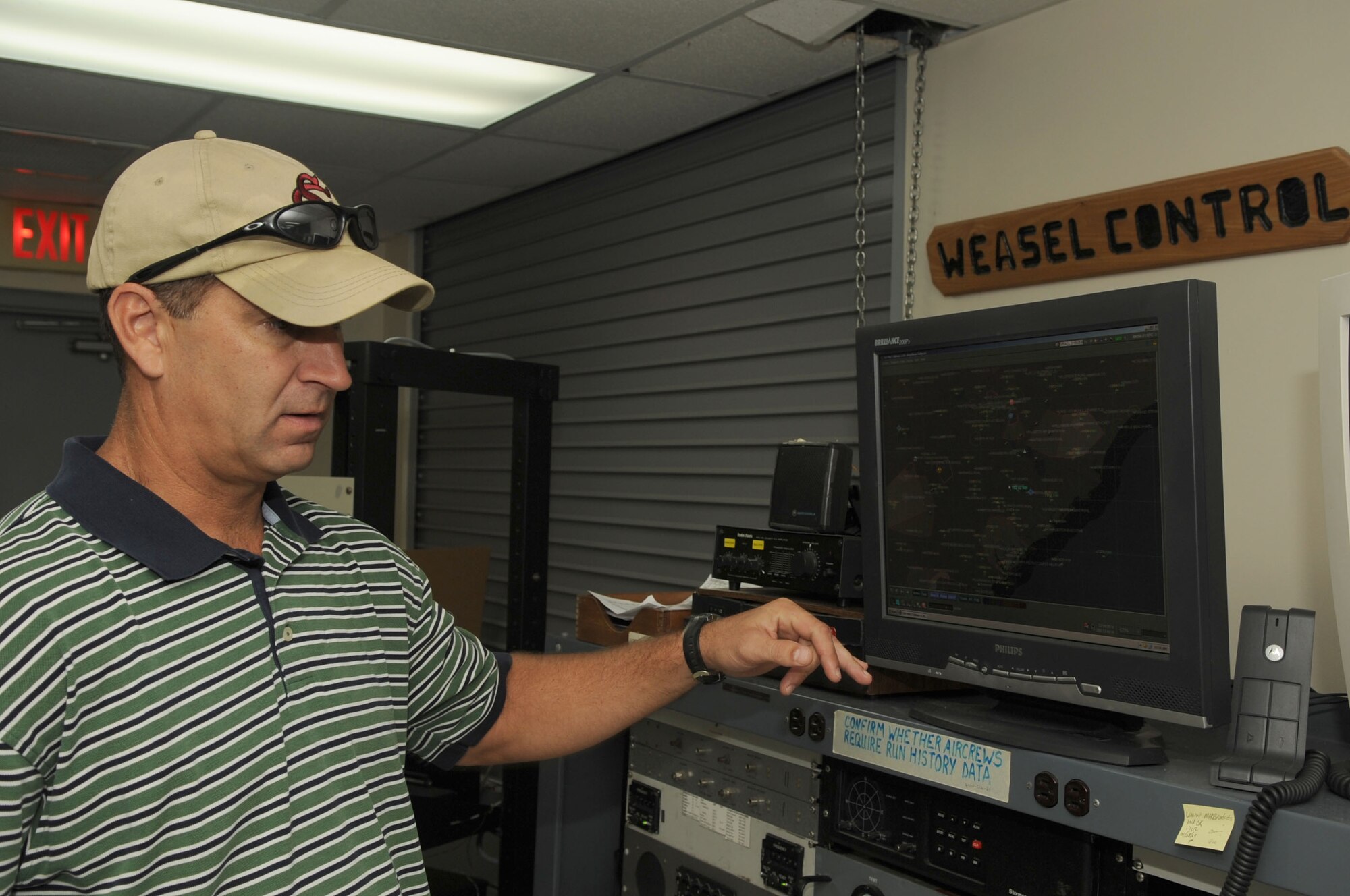 SHAW AIR FORCE BASE, S.C. -- Jeff Stanfield, Electronic Combat deputy site manager, explains the functions of different equipment used to set up excercise scenarios and communicate with the pilots Sept. 1. (U.S. Air Force Photo/Senior Airman David Minor)