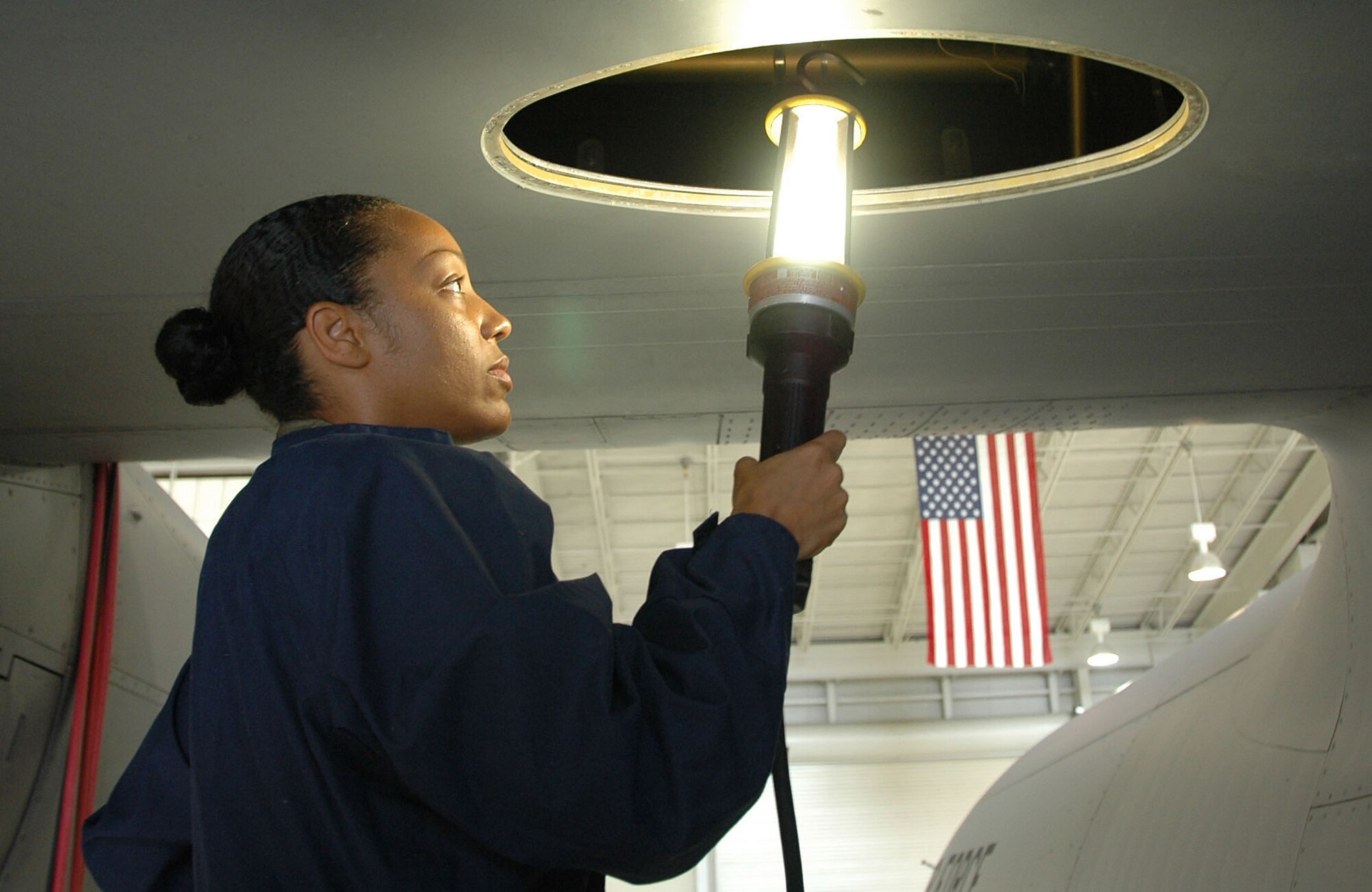 Airman 1st Class Katina Bodden, a fuel systems repair apprentice with the 403rd Maintenance Squadron, performs confined space attendant duties on a C-130J left auxiliary fuel tank. (U.S. Air Force photo by Master Sgt. Michael Duhe)
