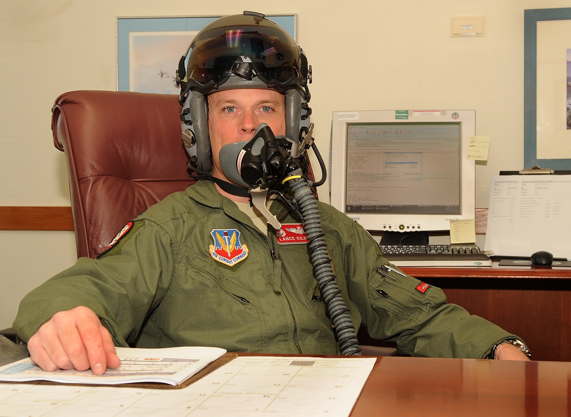 SHAW AIR FORCE BASE, S.C. -- Lieutenant Col. Lance Kildron, 77th Fighter Squadron commander, poses for a photo at his desk Sept. 10. My top goal is to  maintain lethal, combat mission-ready pilots capable of the suppression and destruction of enemy air defenses, he said. (U.S. Air Force Photo/Senior Airman David Minor)
