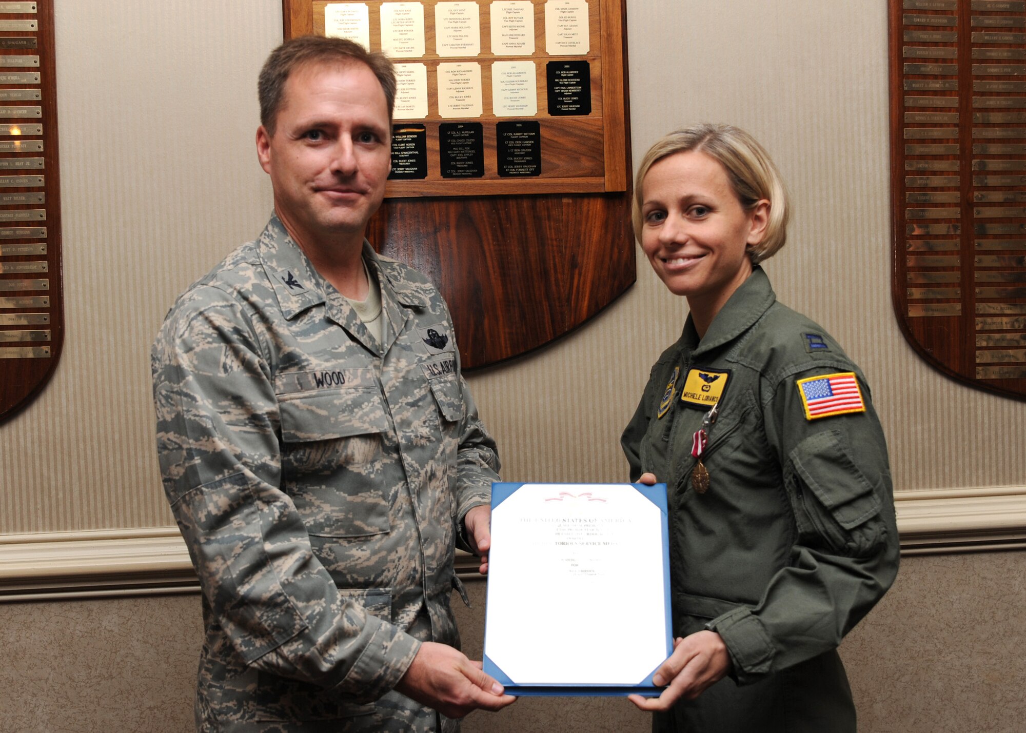 Col. John Wood presents Capt. Michele Lobianco the Meritorious Service Medal award at the Charleston Club, Sept. 23. The Meritorious Service Medal is a military award presented to members of the United States Armed Forces who distinguish themselves by outstanding non-combat meritorious achievement or service to the United States. Colonel Wood is the 437th Airlift Wing commander and Captain Lobianco is the deputy chief of the command post. (U.S. Air Force photo/Senior Airman Katie Gieratz)
