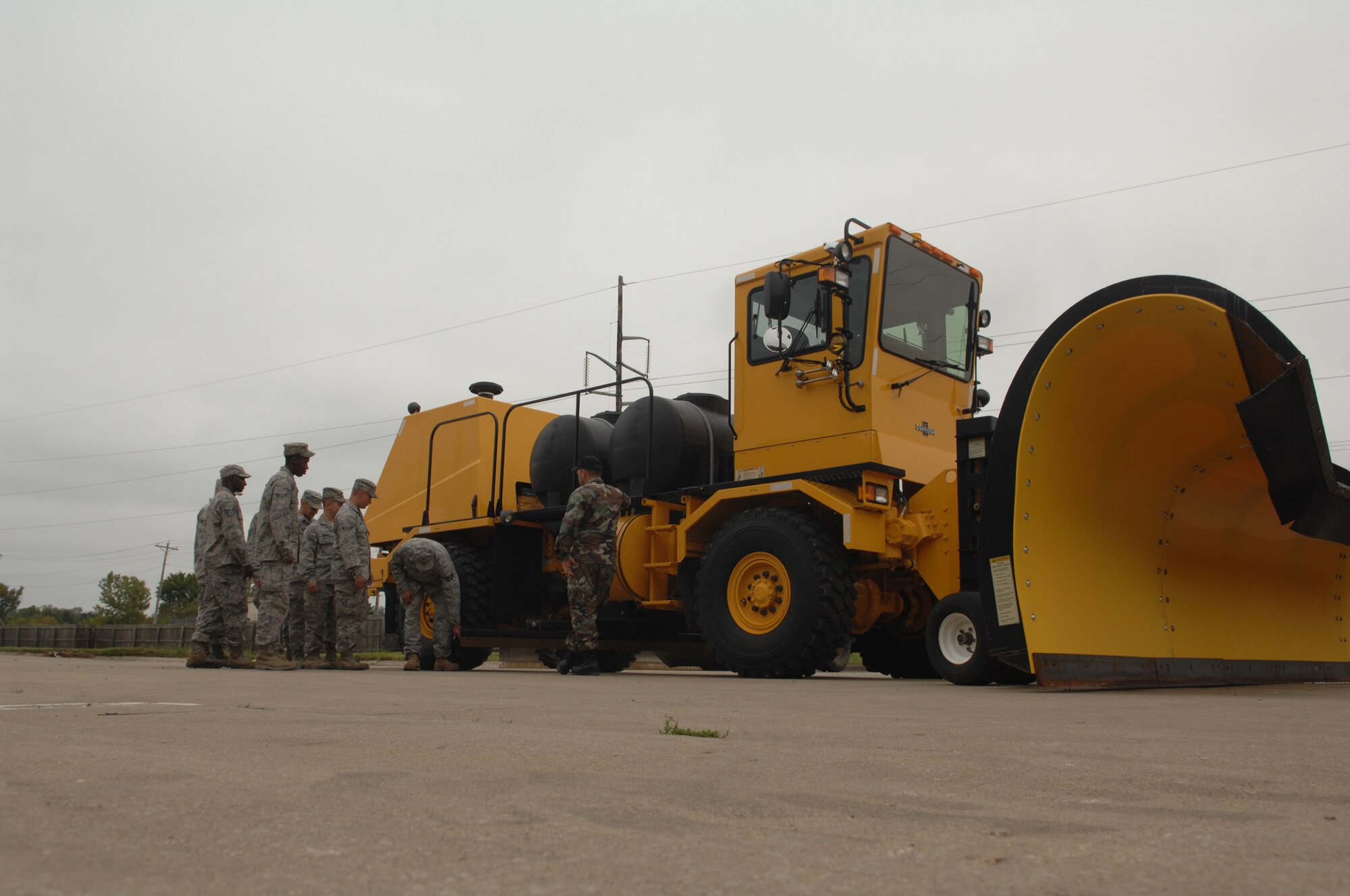 WHITEMAN AIR FORCE BASE, Mo. -- Staff Sgt. Edwin Salgado, 509th Civil Engineer Squadron, gives an equipment familiarization brief on a Rollover Plow to members of the 509th CES. The Rollover Plow is used throughout the winter months to make flight operations possible. (U.S. Air Force photo/Senior Airman Jessica Snow)