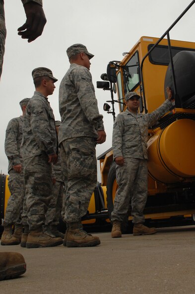 WHITEMAN AIR FORCE BASE, Mo. -- Staff Sgt. Edwin Salgado, 509th Civil Engineer Squadron, gives an equipment familiarization brief on a Rollover Plow to members of the 509th CES. The Rollover Plow is used throughout the winter months to make flight operations possible. (U.S. Air Force photo/Senior Airman Jessica Snow)