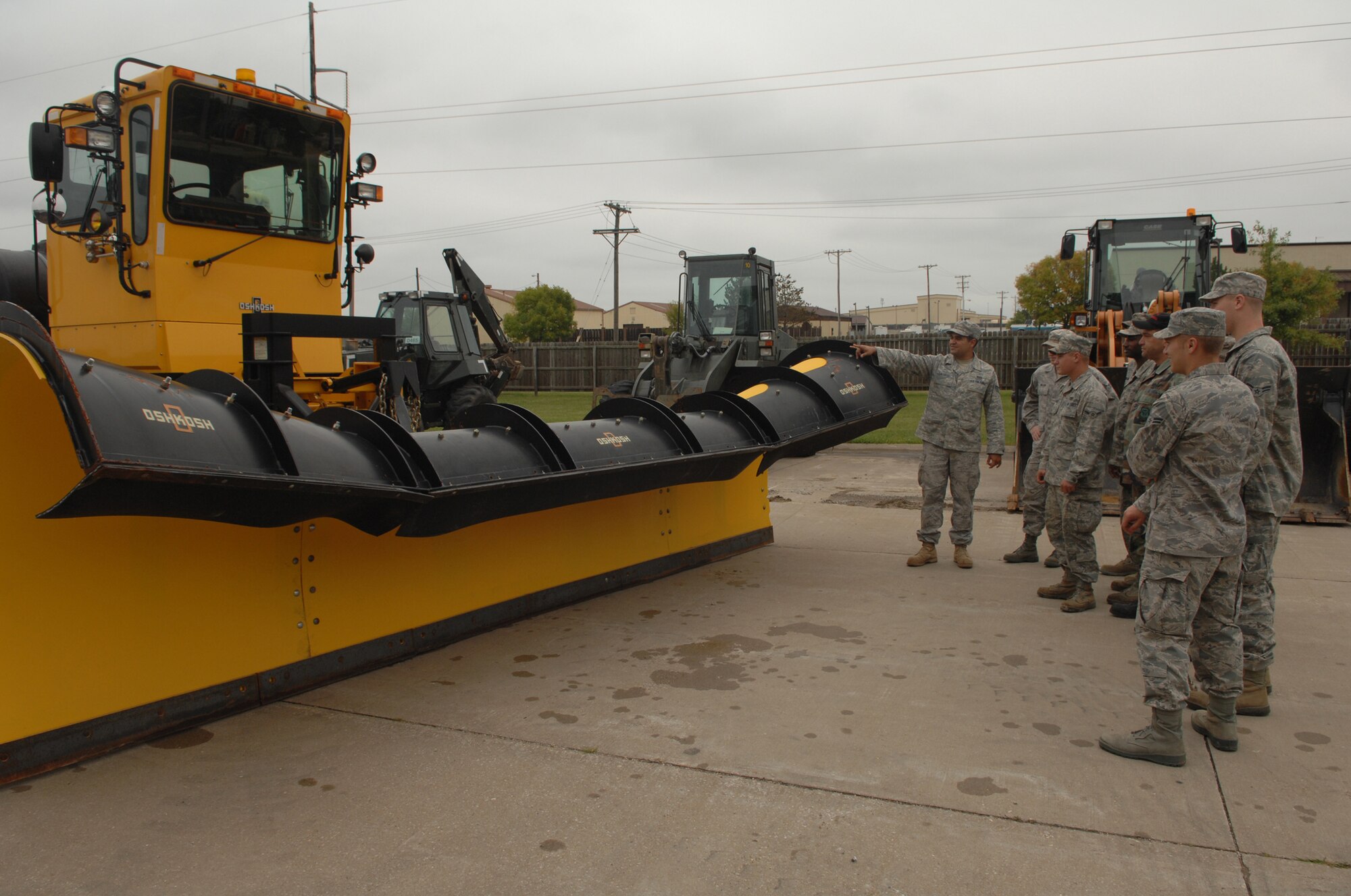 WHITEMAN AIR FORCE BASE, Mo. -- Staff Sgt. Edwin Salgado, 509th Civil Engineer Squadron, gives an equipment familiarization brief on a Rollover Plow to members of the 509th CES. The Rollover Plow is used throughout the winter months to make flight operations possible. (U.S. Air Force photo/Senior Airman Jessica Snow)