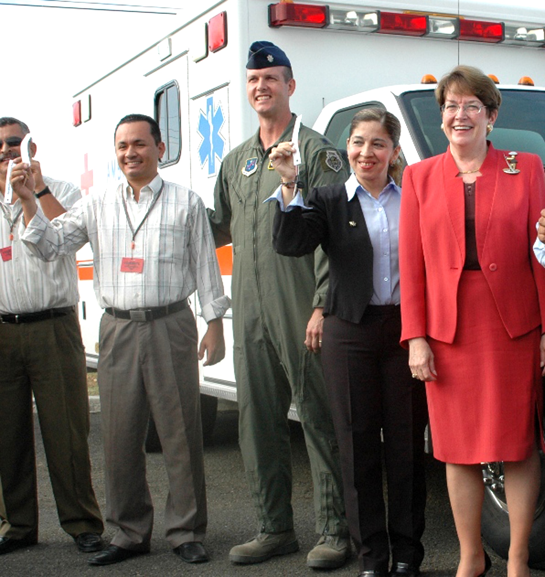 Lt. Col. Jared Curtis (center) stands with local citizens in front of an ambulance donated to an organization Sept. 16, 2009, near Forward Operating Location Manta, Ecuador. To mark the end of 10 years of community relations activities, American military officials donated almost $1 million worth of equipment, food and supplies to local establishments. The forward operating location was deactivated Sept. 18 after a lease between the United States and Ecuador expired. Colonel Curtis is the 478th Expeditionary Operations Squadron commander. (Courtesy photo) 
