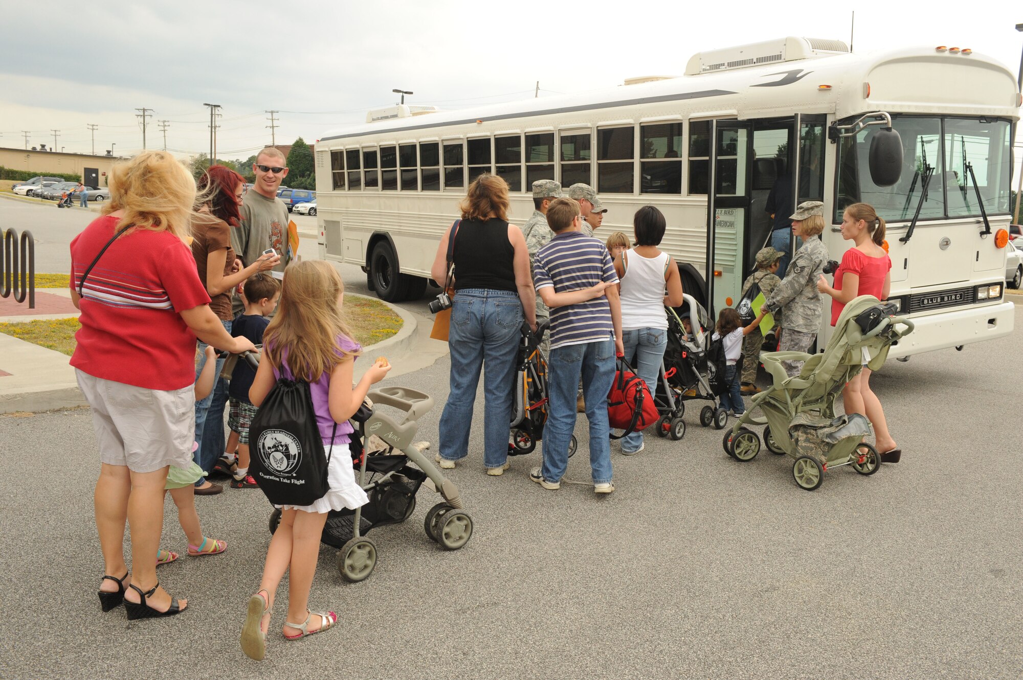 SHAW AIR FORCE BASE, S.C. -- "Operation Take-Flight" participants begin to board the bus as they head to the fictional country Shawkikistan for their simultaed deployment experience Sept. 17. Children, ages 4 to12, got to experience what their mom and dad go through when deploying, which gives them a better understanding of the deployment process and helps relieve anxiety. (U.S. Air Force photo/Senior Airman David Minor)