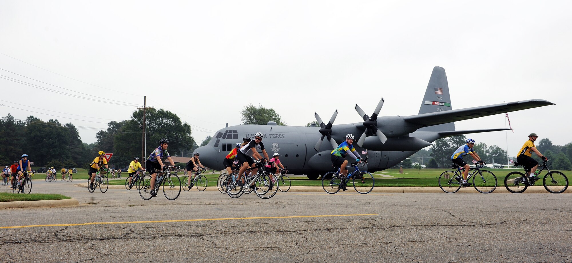 Cyclists convoy in front of a C-130 static display on Little Rock Air Force Base in support of the Wounded Warrior Bike Ride Saturday. Approximately 350 cyclists participated in the event and approximately $12,000 was raised for the Wounded Warrior fund. (U.S. Air Force photo by Senior Airman Ethan Morgan)