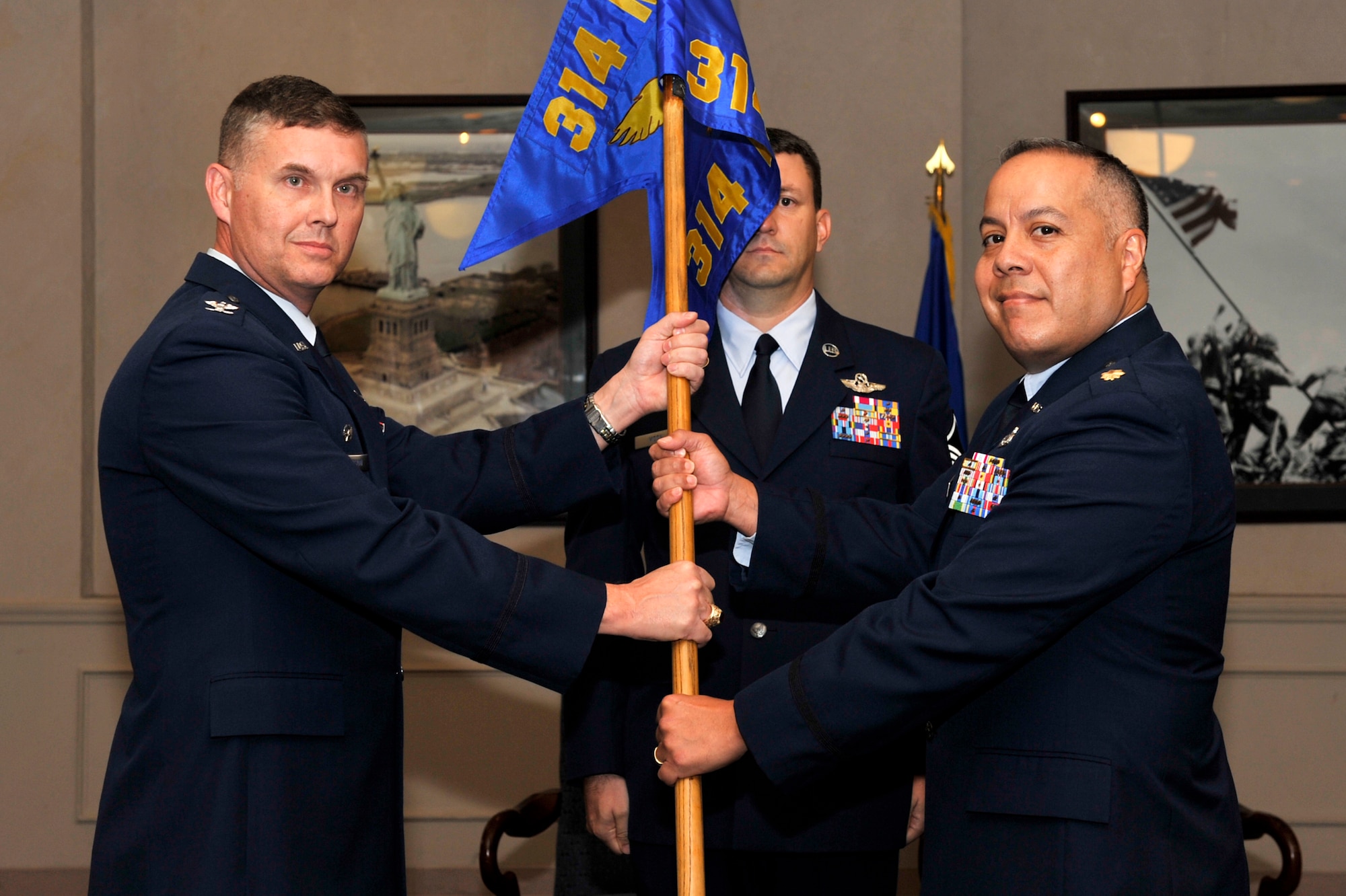 Col. Adam Dickerson, 314th Maintenance Group commander, passes the 314th Maintenance Operations Squadron guidon to Maj. Dennis Higuera, new 314th MOS commander, during the 314th MOS assumption of command ceremony Sept. 16.  The 314 MOS’s mission is to sustain the wing’s mission to train the world’s best C-130 and C-21 airlifters to fly, fight and win while simultaneously upholding the 314 MOS’s motto, “the best of the best.” There are approximately 60 Airmen in the squadron. (U.S. Air Force photo by Airman 1st Class Lausanne Pacheco)