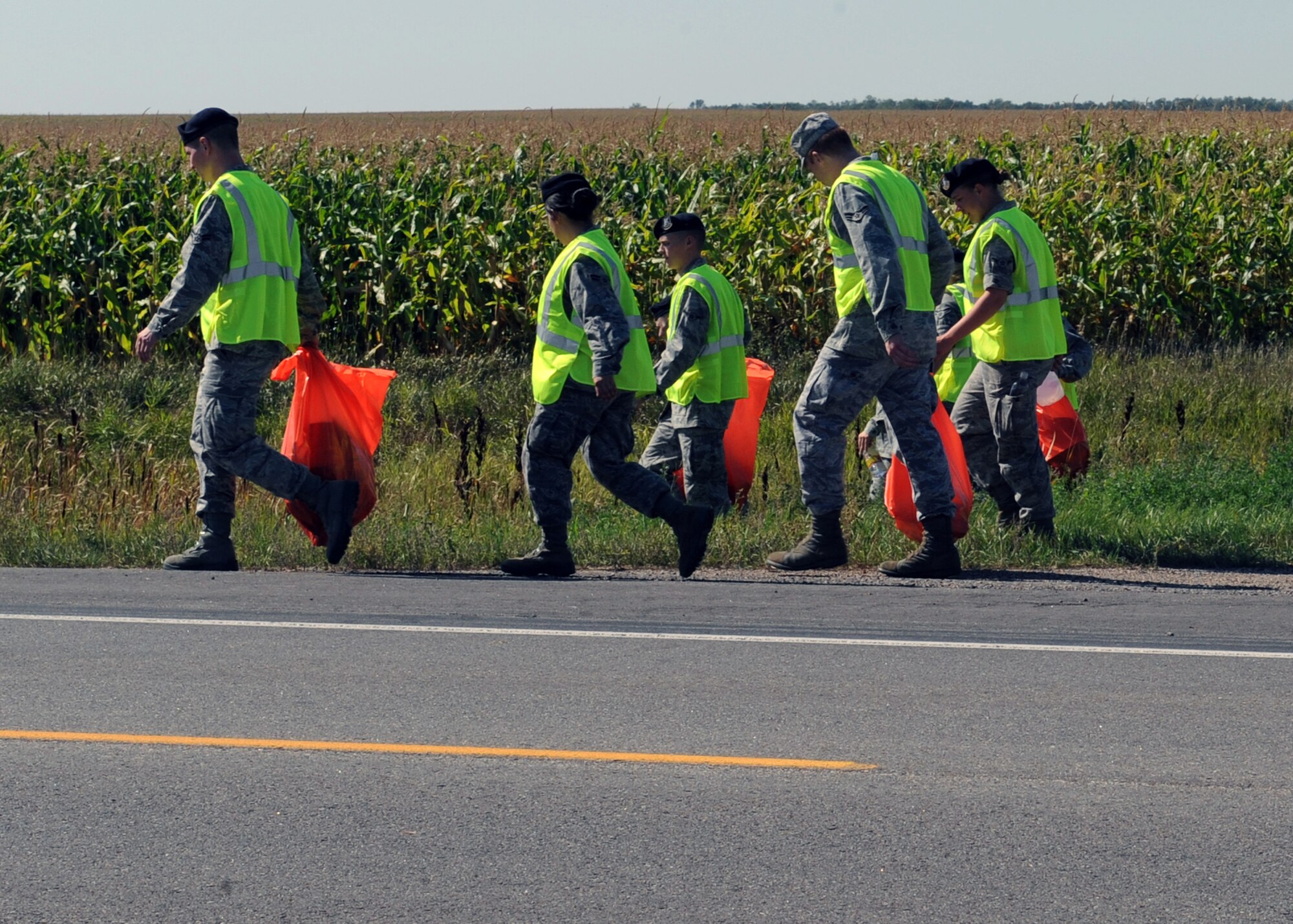 MINOT AIR FORCE BASE, N.D. -- 5th Security Forces Squadron training flight personnel clean a three-mile section of highway 83 as a part of Wingman Day here, Sept. 18.  The 5th Bomb Wing event, which coincided with the Air Force’s 62nd birthday, was held as a means to strengthen the morale and welfare of each unit by empowering and encouraging Airmen to not only become great wingmen, but future leaders. (U.S. Air Force photo by Staff Sgt. Keith Ballard)