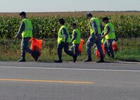 MINOT AIR FORCE BASE, N.D. -- 5th Security Forces Squadron training flight personnel clean a three-mile section of highway 83 as a part of Wingman Day here, Sept. 18.  The 5th Bomb Wing event, which coincided with the Air Force’s 62nd birthday, was held as a means to strengthen the morale and welfare of each unit by empowering and encouraging Airmen to not only become great wingmen, but future leaders. (U.S. Air Force photo by Staff Sgt. Keith Ballard)