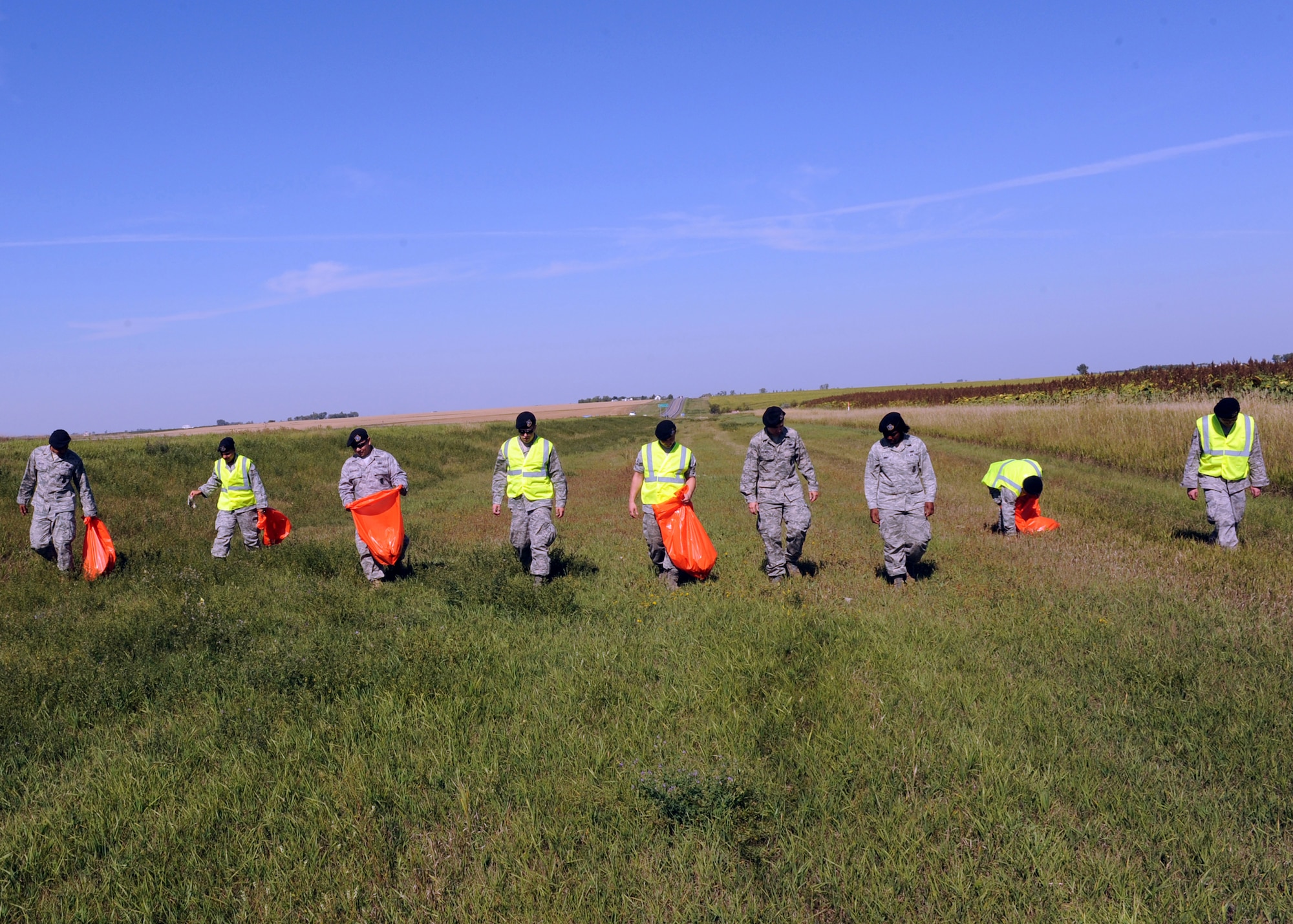 MINOT AIR FORCE BASE, N.D. -- 5th Security Forces Squadron training flight personnel clean a three-mile section of highway 83 as a part of Wingman Day here, Sept. 18.  The 5th Bomb Wing event, which coincided with the Air Force’s 62nd birthday, was held as a means to strengthen the morale and welfare of each unit by empowering and encouraging Airmen to not only become great wingmen, but future leaders. (U.S. Air Force photo by Staff Sgt. Keith Ballard)