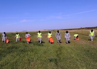 MINOT AIR FORCE BASE, N.D. -- 5th Security Forces Squadron training flight personnel clean a three-mile section of highway 83 as a part of Wingman Day here, Sept. 18.  The 5th Bomb Wing event, which coincided with the Air Force’s 62nd birthday, was held as a means to strengthen the morale and welfare of each unit by empowering and encouraging Airmen to not only become great wingmen, but future leaders. (U.S. Air Force photo by Staff Sgt. Keith Ballard)