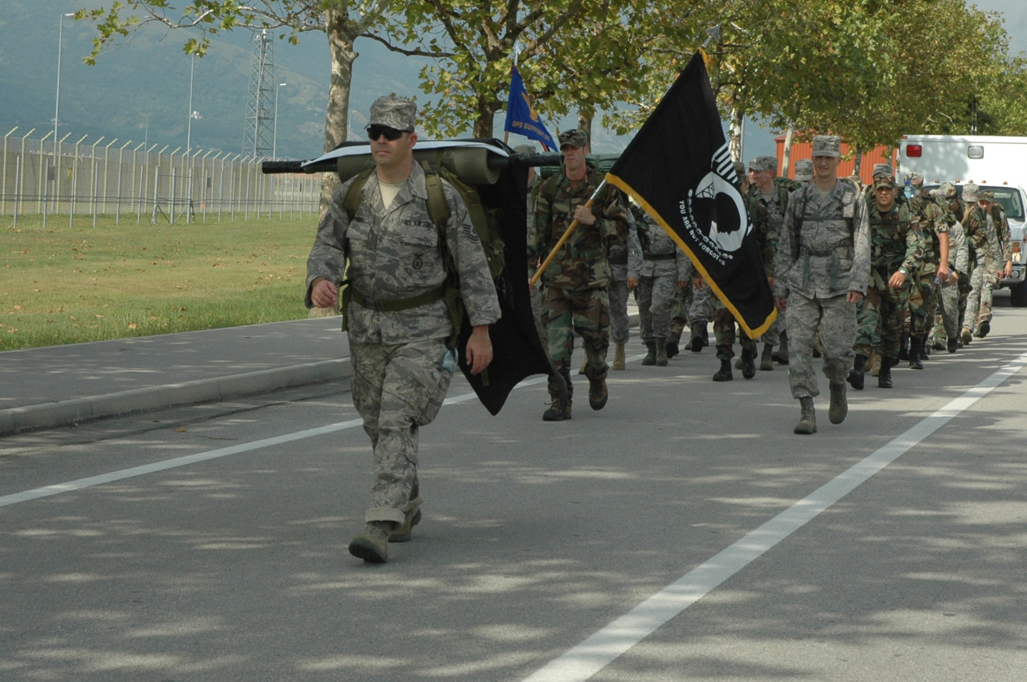 A formation of Airmen wrapped-up a series of events Sept. 18, 2009 with a "ruck sack" march around the flightline of Aviano Air Base, Italy.  A joint U.S.-Italian Air Forces POW/MIA retreat ceremony immediately followed the approximate six-mile march around the base's flightline area and ended outside the ITAF Headquarter Building where the retreat ceremony was held.  (U.S. Air Force photo/Staff Sgt. Mercedes Crossland)