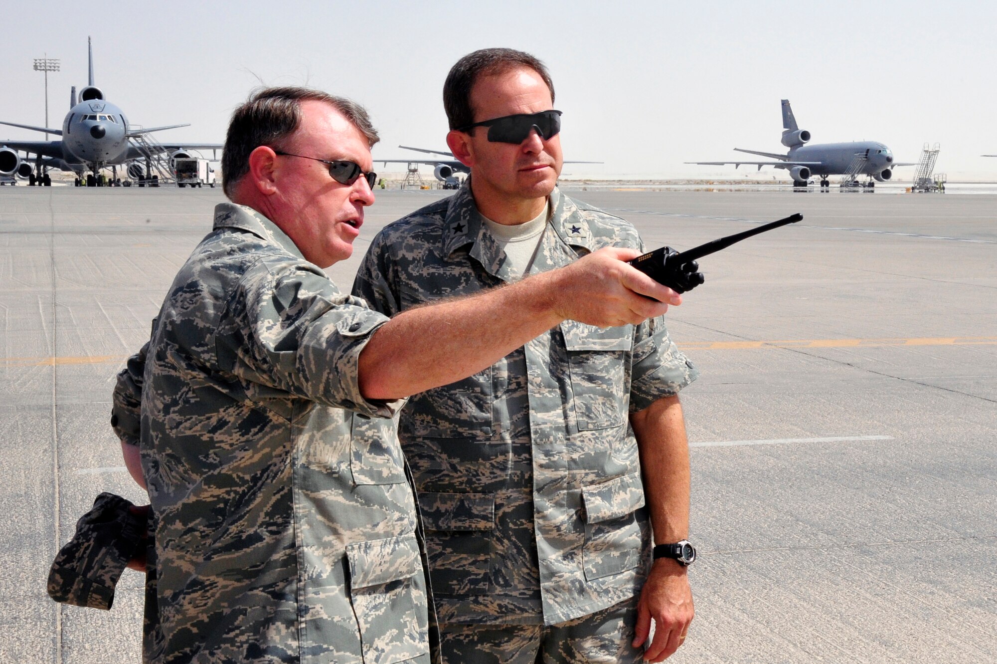 SOUTHWEST ASIA - Brig. Gen. Bryan Benson, 380th Air Expeditionary Wing commander, points out key structures on the flight line to Maj. Gen. (Select) Timothy Byers, the Air Force Engineer, here Sept. 20, 2009. General Benson escorted General Byers through a tour of the base facilities. (U.S. Air Force photo/Tech. Sgt. Charles Larkin Sr)