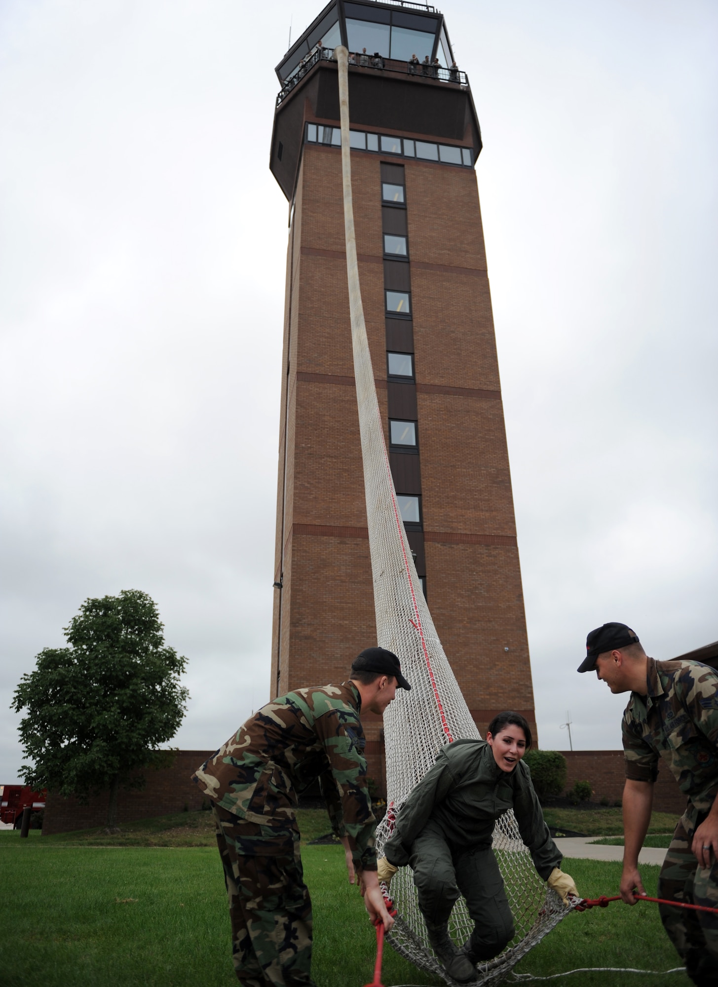 WHITEMAN AIR FORCE BASE, Mo. – Airman 1st Class Anna Mayerhofer, 509th Operations Support Squadron airfield management, slides down the tower slide and is helped out by members of the 509th Fire Department Sept. 22. Personal who work in the tower must go through the proper training to insure they can escape from the tower in case of an emergency. (U.S. Air Force photo/Senior Airman Cory Todd)