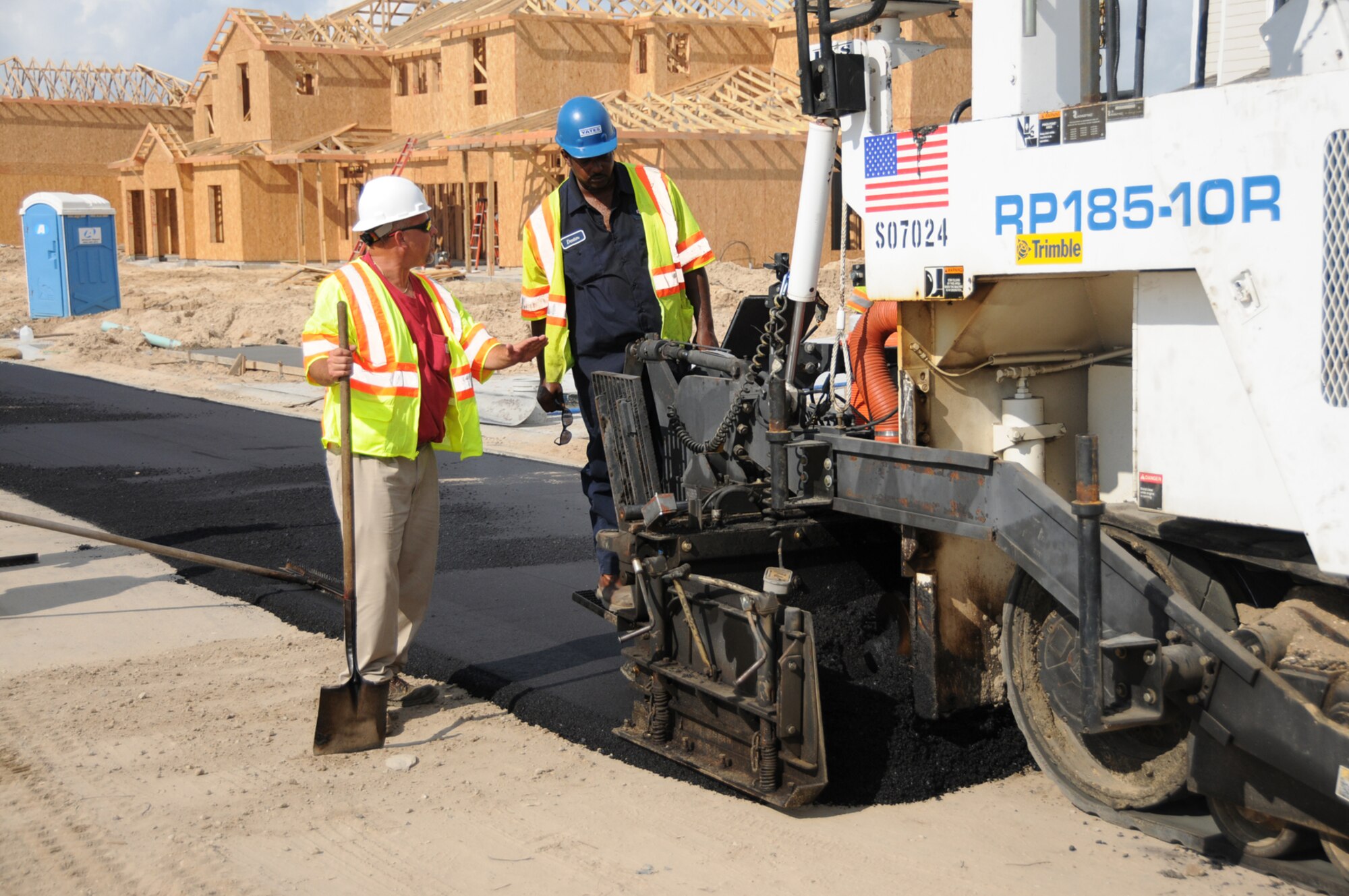 Superintendent Chris Key and operator Dexter White from Superior Asphalt pave a street in Bay Ridge.  (U.S. Air Force photo by Kemberly Groue)