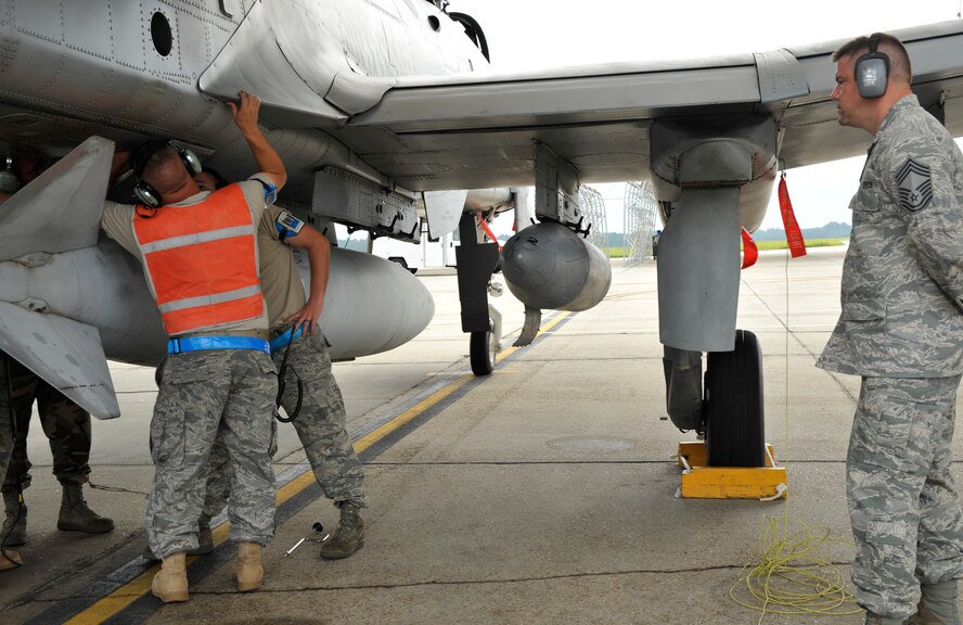 MOODY AIR FORCE BASE, Ga. -- While Airmen from the 23rd Aircraft Maintenance Squadron work to prepare an aircraft for a simulated deployment, Chief Master Sgt. Galen Wilson, Air Combat Command Inspector General team member, from Langley Air Force Base, Va., observes the process during the Phase I Operational Readiness Inspection here Sept. 22. (U.S. Air Force photo by Senior Airman Schelli Jones)