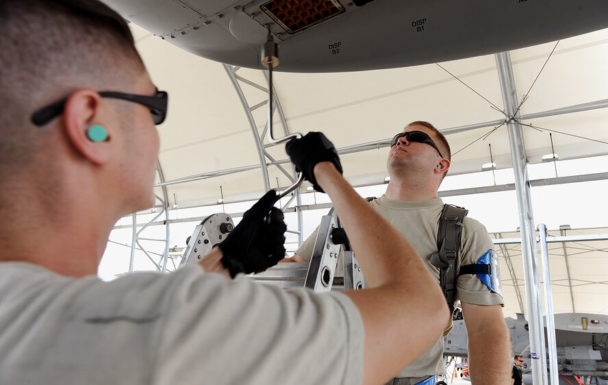 MOODY AIR FORCE BASE, Ga. -- Senior Airman Jacob Garbes and Staff Sgt. Kyle Blouin, 74th Aircraft Maintenance Unit weapons flight members, install chaff flares on to an A-10C Thunderbolt II during the Phase I Operational Readiness Inspection here Sept 21. During the inspection, the aircraft’s ability to be ready for rapid deployment is tested. (U.S. Air Force photo by Airman 1st Class Joshua Green)