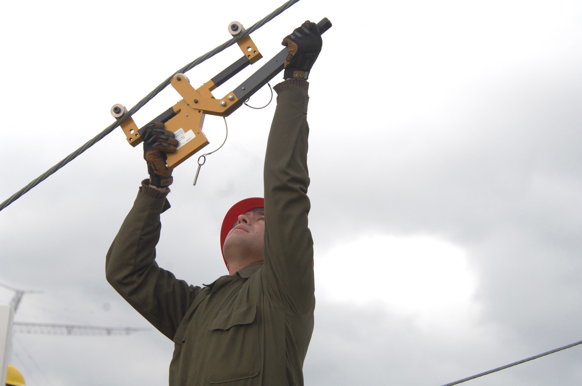 Staff Sgt. Carlos Salinas measures the pressure on a guy wire that holds tension through tie-down points connected to a radio tower Sept. 18, 2009, at Royal Air Force Barford, England. Sergeant Salinas is a member of the 1st Communications Maintenance Squadron cable and antenna theater maintenance team. (U.S. Air Force photo/Tech. Sgt. Michael Voss) 