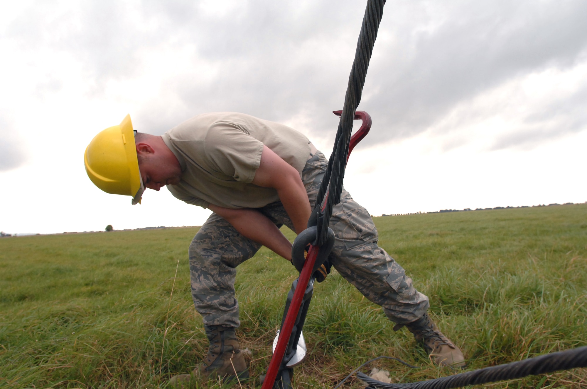 Staff Sgt. Scot Craig loosens a guy wire, which holds tension through tie-down points connected to a radio tower Sept. 18, 2009, at Royal Air Force Barford, England. Sergeant Craig is a member of the 1st Communications Maintenance Squadron cable and antenna theater maintenance team from Kapaun Air Station, Germany. (U.S. Air Force photo/Tech. Sgt. Michael Voss) 