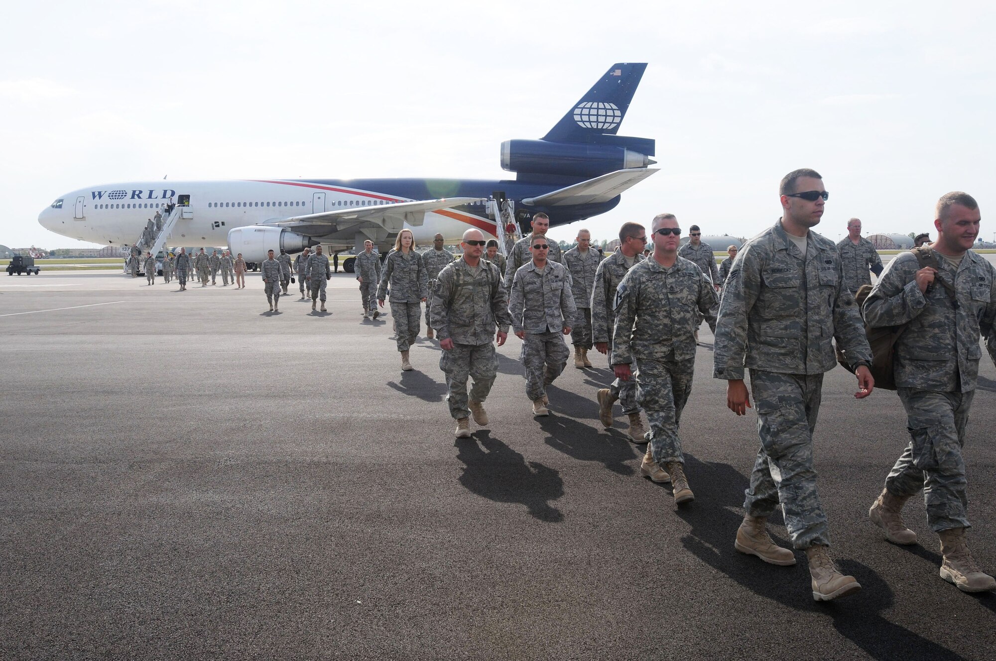 Military servicemembers returning from deployment disembark a government chartered aircraft arriving from an air base in Southwest Asia Sept. 11, 2009, at Aviano Air Base, Italy. The servicemembers were amongst the first to use the new passenger and air freight terminal at Aviano AB since it opened for passenger processing Sept. 10. (U.S. Air Force photo/Airman 1st Class Ashley Wood) 
