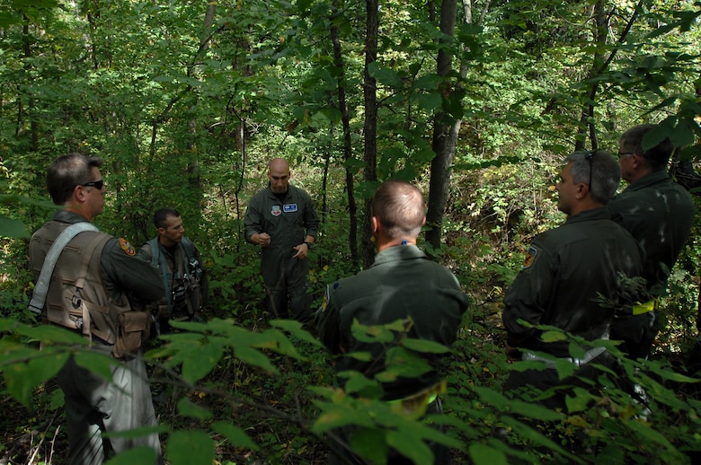 WHITEMAN AIR FORCE BASE, Mo. - Staff Sgt. Michael Garcia (center) , 509th Operations Support Squadron search and rescue specialist, trains 303rd Fighter Squadron pilots on the techniques needed to survive if their aircraft were to go down behind enemy lines, Sept. 16. The training was part of the 442nd Phase II exercise. (U.S. Air Force photo/Senior Airman Kenny Holston)