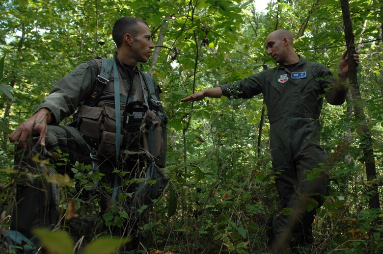 WHITEMAN AIR FORCE BASE, Mo. - Staff Sgt. Michael Garcia (right) , 509th Operations Support Squadron search and rescue specialist, explains cover and concealment techniques to Capt. Lance Orr, 303rd Fighter Squadron fighter pilot, during a class designed to equip fighter pilots with the skills needed to survive if their aircraft ever went down behind enemy lines, Sept. 16. The 303rd fighter pilots are stationed at here and fly the A-10 Warthogs. (U.S. Air Force photo/Senior Airman Kenny Holston)