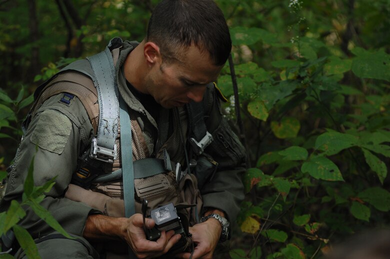 WHITEMAN AIR FORCE BASE, Mo. - Capt. Lance Orr, 303rd Fighter Squadron fighter pilot, adjusts his field radio during a class designed to equip fighter pilots with the skills needed to survive if their aircraft ever went down behind enemy lines, Sept. 16. Captain Orr and other 303rd pilots were instructed by Staff Sgt. Michael Garcia, 509th Operations Support Squadron search and rescue specialist. They participated in extensive class room and field training. The 303rd fighter pilots are stationed at here and fly the A-10 Warthogs.(U.S. Air Force photo/Senior Airman Kenny Holston)