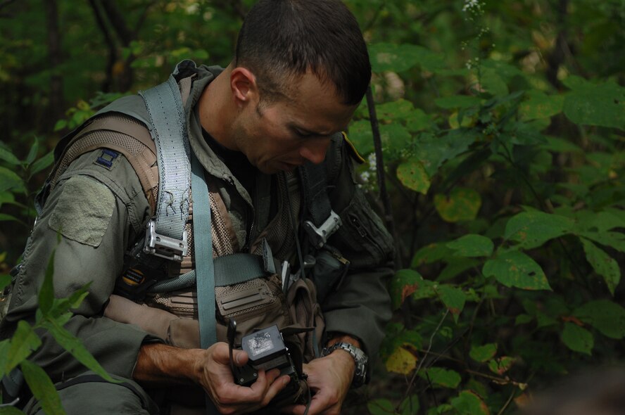 WHITEMAN AIR FORCE BASE, Mo. - Capt. Lance Orr, 303rd Fighter Squadron fighter pilot, adjusts his field radio during a class designed to equip fighter pilots with the skills needed to survive if their aircraft ever went down behind enemy lines, Sept. 16. Captain Orr and other 303rd pilots were instructed by Staff Sgt. Michael Garcia, 509th Operations Support Squadron search and rescue specialist. They participated in extensive class room and field training. The 303rd fighter pilots are stationed at here and fly the A-10 Warthogs.(U.S. Air Force photo/Senior Airman Kenny Holston)