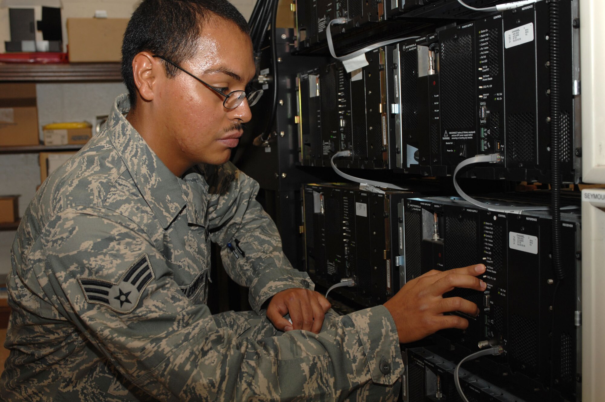 Senior Airman Jose Charlesworth, 4th Communications Squadron radio technician, disables a control channel in a trunk site repeater on Seymour Johnson Air Force Base, N.C., Sept. 16, 2009. Repeaters are the backbone of the land mobile radio system because they control the operation of radio channels. (U.S. Air Force photo by Staff Sgt. Heather Stanton)