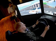 Capt. Jason Richardson tests out a drunk driving simulator at the base theater here during the Save a Life Tour Sept. 22. The multi-million dollar simulators used by Save a Life Tour are the only simulators in the country which give participants a completely realistic, sober perspective on the effects of driving while intoxicated. Captain Richardson is a flight safety officer with the 437th Airlift Wing Safety Office. (U.S. Air Force photo/Senior Airman Katie Gieratz)