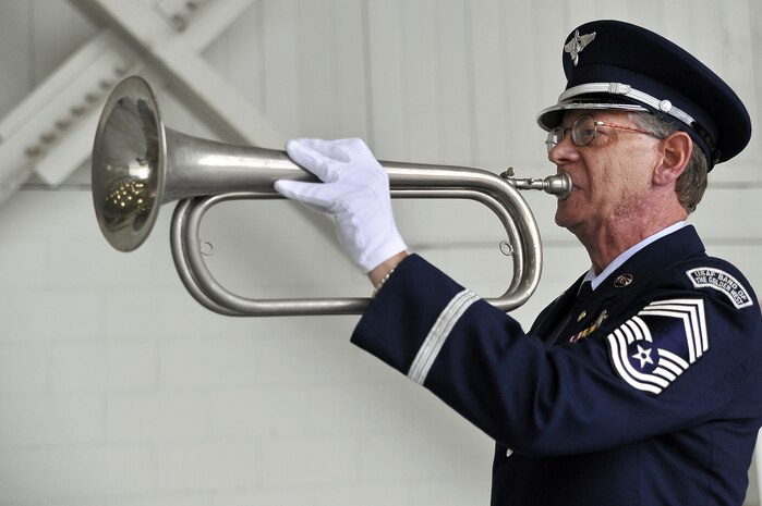 Ret. Chief Master Sgt. Thomas Kistler plays taps at the close of a retreat ceremony here Sept. 18. The ceremony was held in honor of prisoners of war, those listed as missing in action and family members who share in the sacrifices of freedom. Mr. Kistler is a palace acquire intern with the 437th Airlift Wing Public Affairs Office. (U.S. Air Force photo/James Bowman)