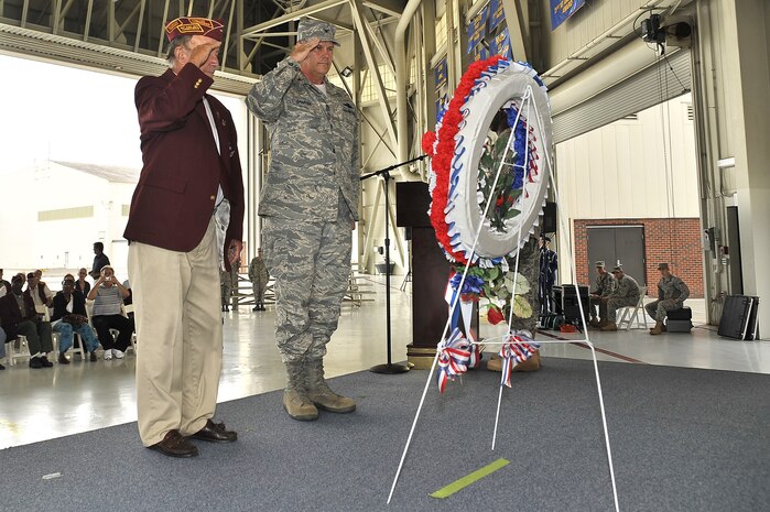 Col. Don Shaffer and Reggie Salisbury salute a prisoner of war, missing in action wreath during a retreat ceremony here Sept. 18. The wreath was presented in memory of those who perished while in captivity during military service, paying the ultimate price of liberty. Colonel Shaffer is the 437th Airlift Wing vice commander and Mr. Salisbury is the American ex-Prisoners of War Lowcountry Chapter commander. (U.S. Air Force photo/James Bowman)
