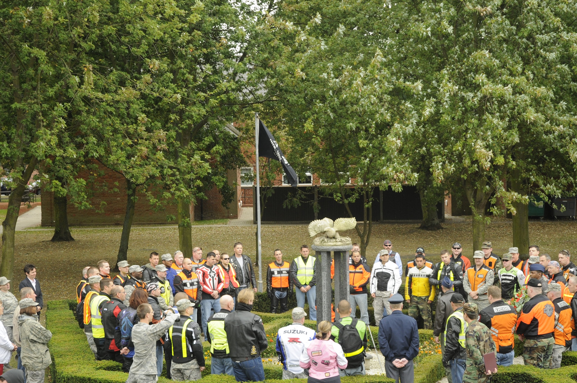 Bikers gather around the POW/MIA memorial to have a moment of silence during a wreath laying, Sept. 15, 2009, at RAF Mildenhall, England. More than 50 riders gathered together to pay tribute to those who have made the ultimate sacrifice for their country. (U.S. Air Force photo/ Airman 1st Class Eboni Knox) 