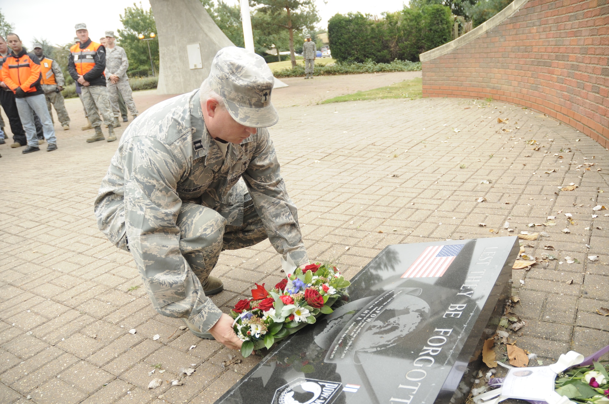 Chaplain (Capt.) Richard Holmes, 48th Fighter Wing chaplain, lays a wreath at the 48th Fighter Wing Memorial Park on Sept. 15, 2009, at RAF Lakenheath, England. Chaplain Holmes followed motorcycle riders from the POW/MIA Motorcycle Ride to the park to pay his respects to servicemembers held as prisoners of war or classified as missing in action. (U.S. Air Force photo/ Airman 1st Class Eboni Knox) 