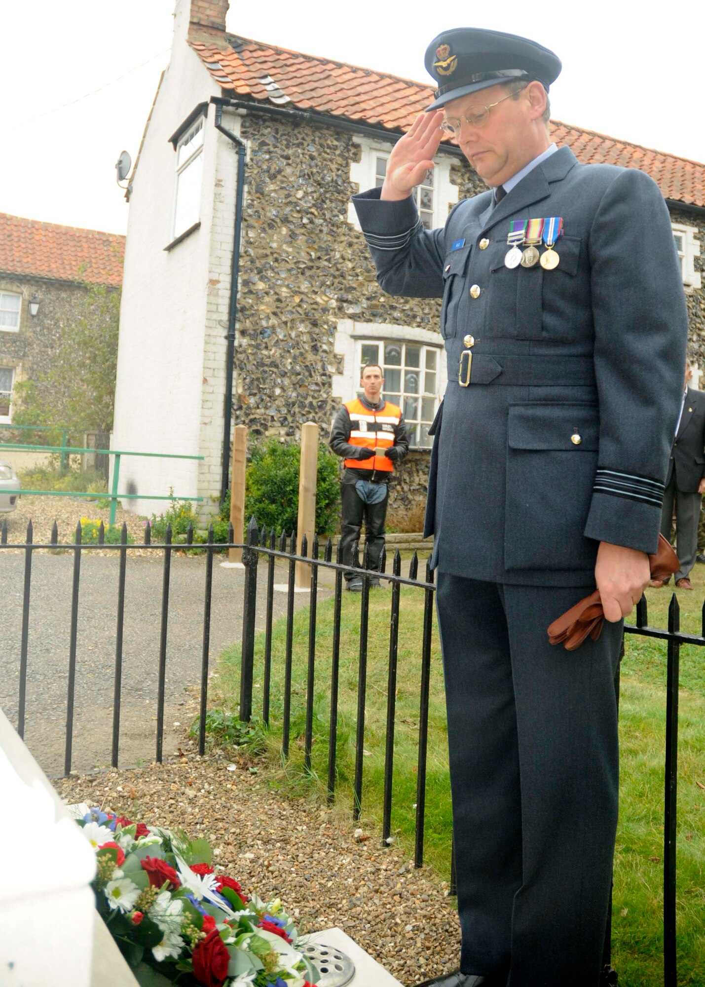 Sqd. Ldr. Jerry Neild, RAF commander at Lakenheath, pays his respects to those who have made the ultimate sacrifice for their countries by rendering a salute to the Lakenheath Village memorial statue, Sept. 15, 2009. Sqn. Ldr. Neild was following the POW/MIA Motorcycle Ride as they lay wreaths at four different memorials along the way. (U.S. Air Force photo/ Airman 1st Class Eboni Knox)
