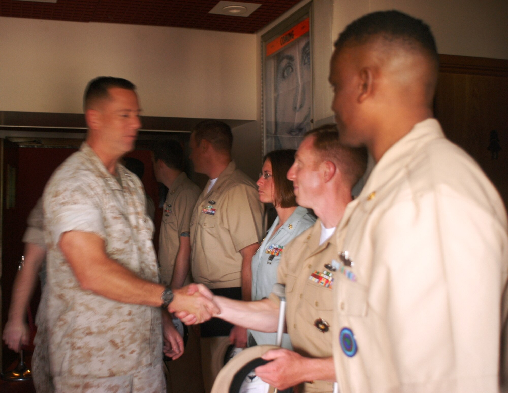 Col. Peter Devlin, JAC Commander, congratulates the new chiefs (left to right—Jamie Harmening, Shane Reisnour, Charlene Potter, and Paul Fleming) after their pinning ceremony.  (Photo by Melony Angelilli)